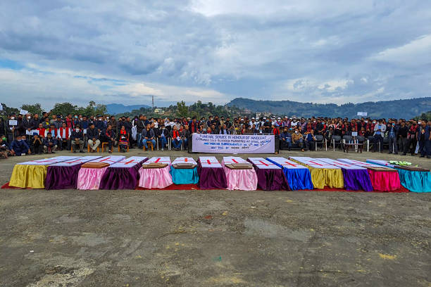 File photo: People attend a mass funeral of 14 civilians killed by Indian security forces in December 2021