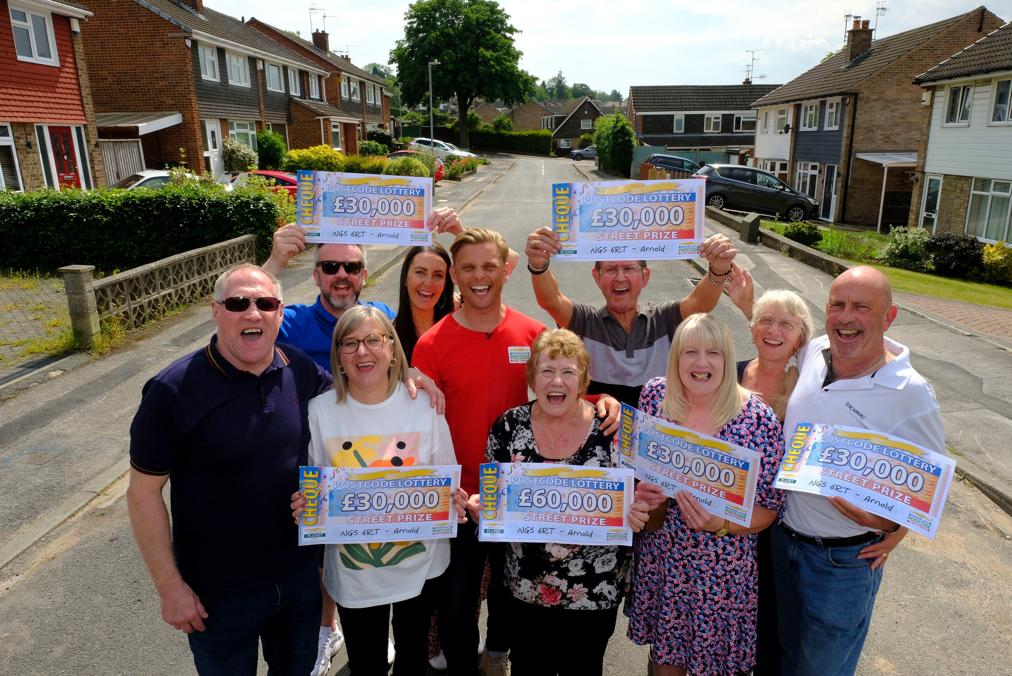 Eight neighbours in Arnold, Nottinghamshire, celebrating after winning a combined £270,000 with People’s Postcode Lottery on Sunday