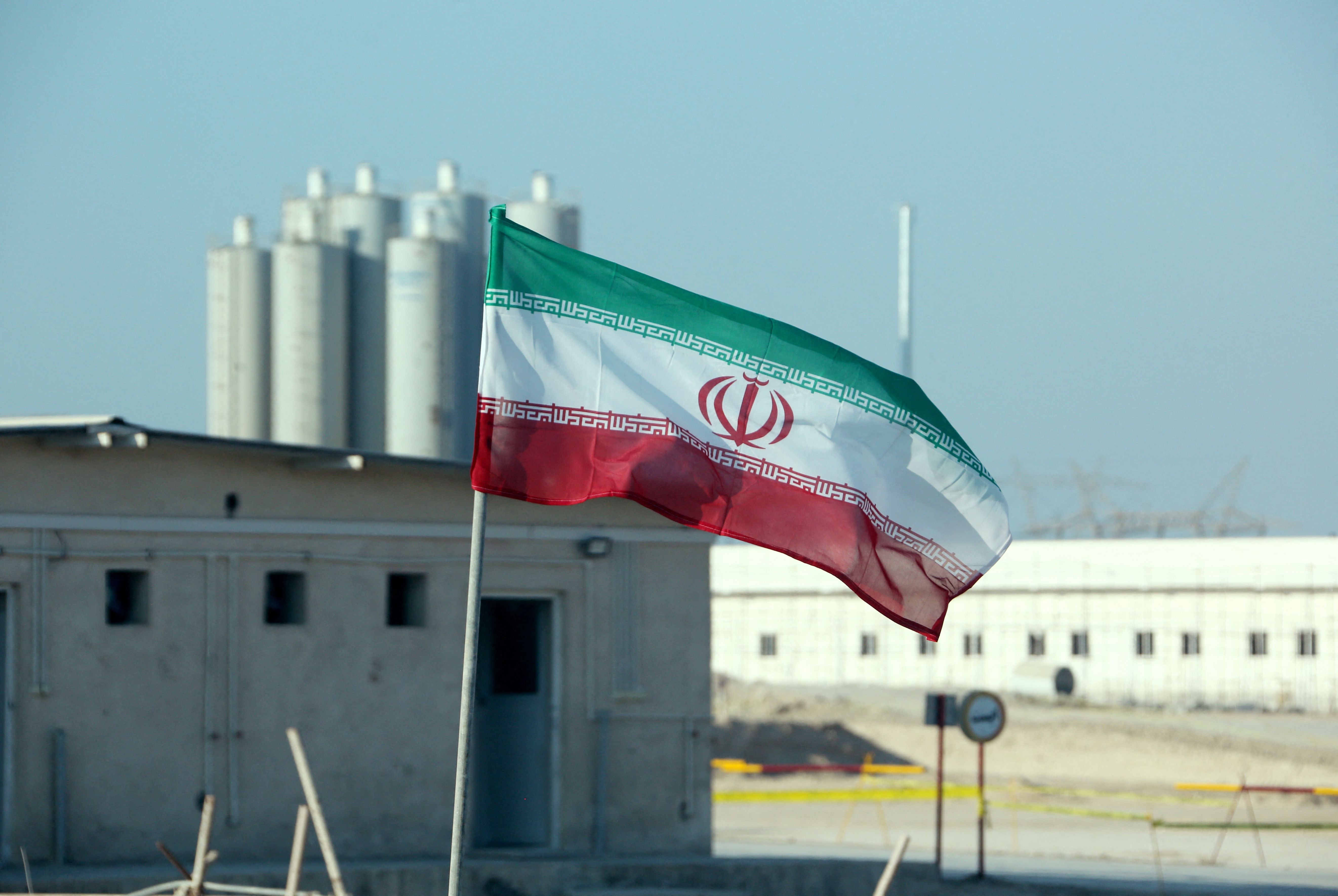 The Iranian flag flutters in front of Bushehr nuclear power plant