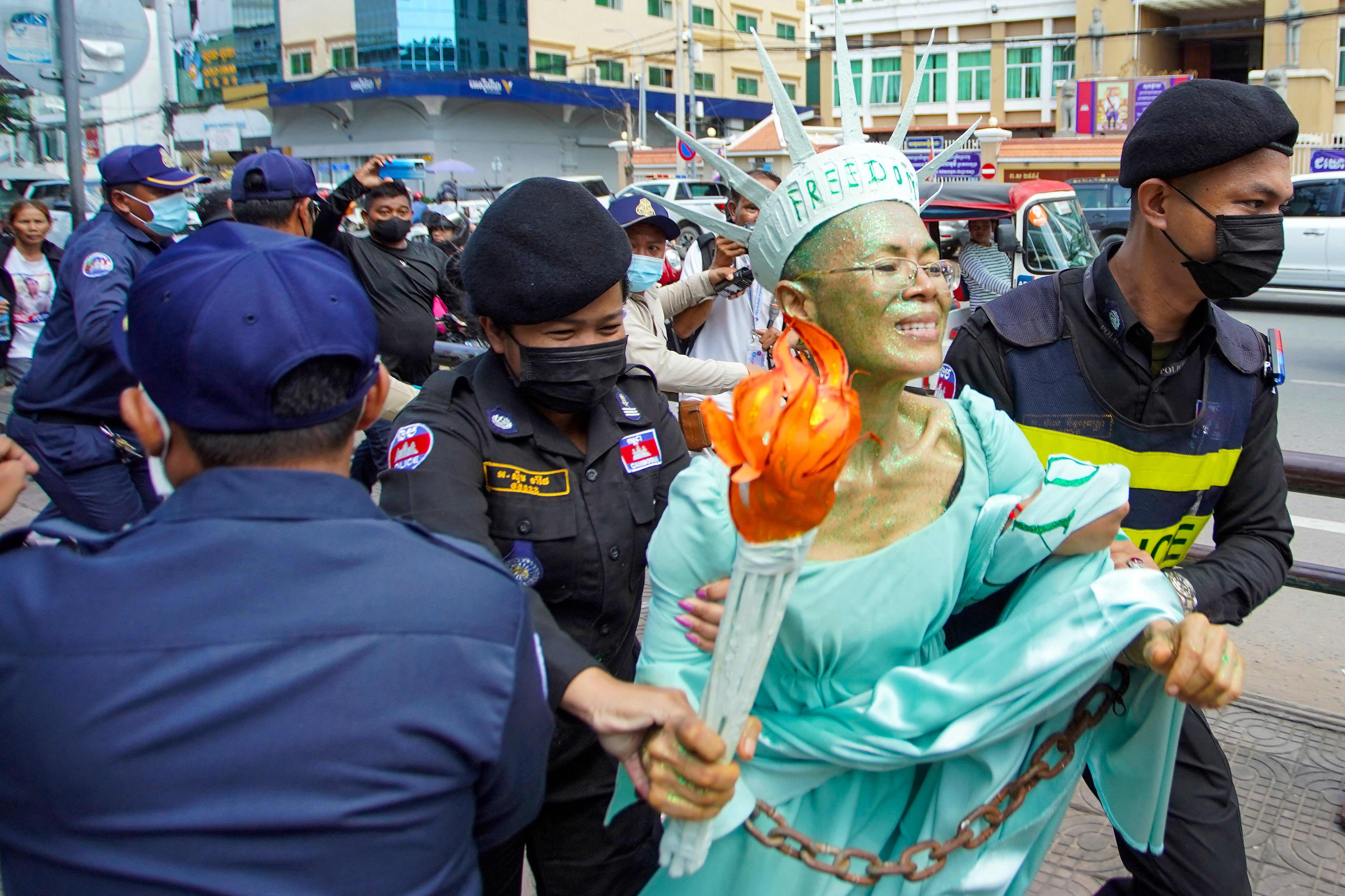 Cambodian-US human rights advocate Theary Seng, dressed as Lady Liberty, is arrested by police after being found guilty of treason in her trial in front of the Phnom Penh municipal court