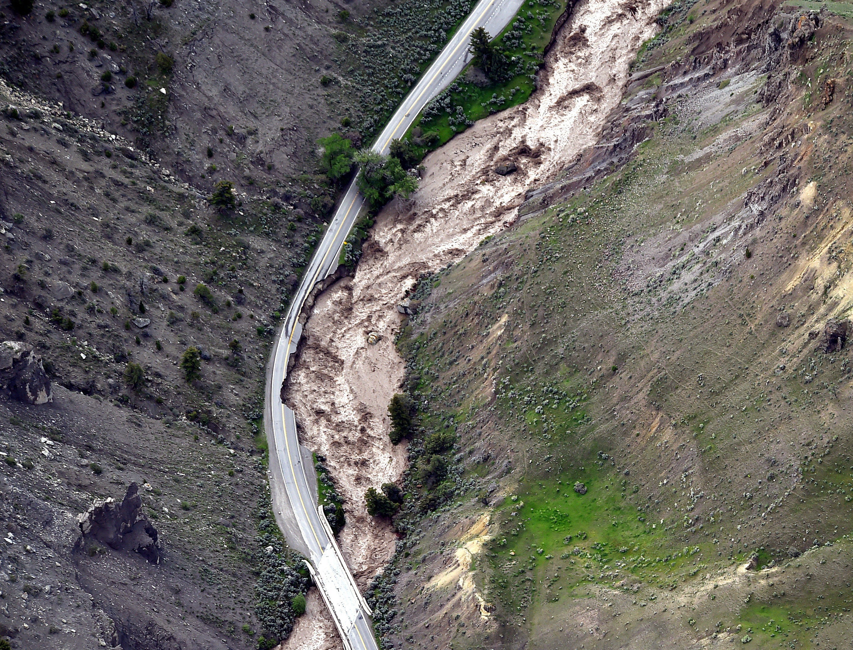 The highway between Gardiner and Mammoth in Montana is washed out trapping tourists in Gardiner, as historic flooding damages roads and bridges and floods homes along area rivers on Monday, June 13, 2022