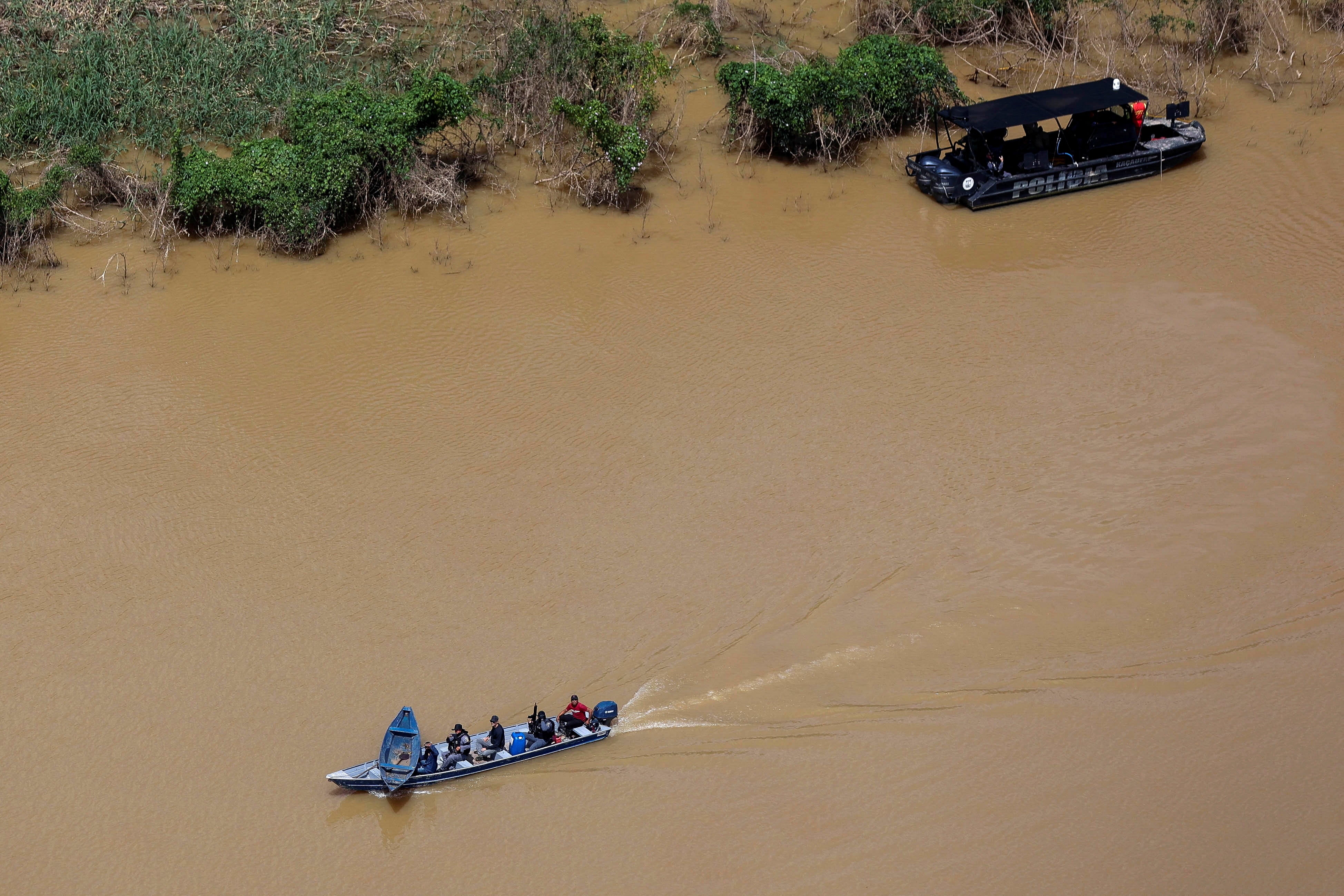 Police officers and rescue team conduct a search operation for missing pair