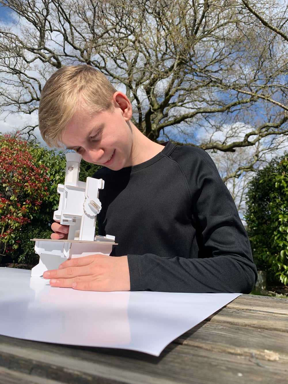 Keith Finch’s son, Tom Finch, testing the paper microscope prototype (Collect/PA Real Life)