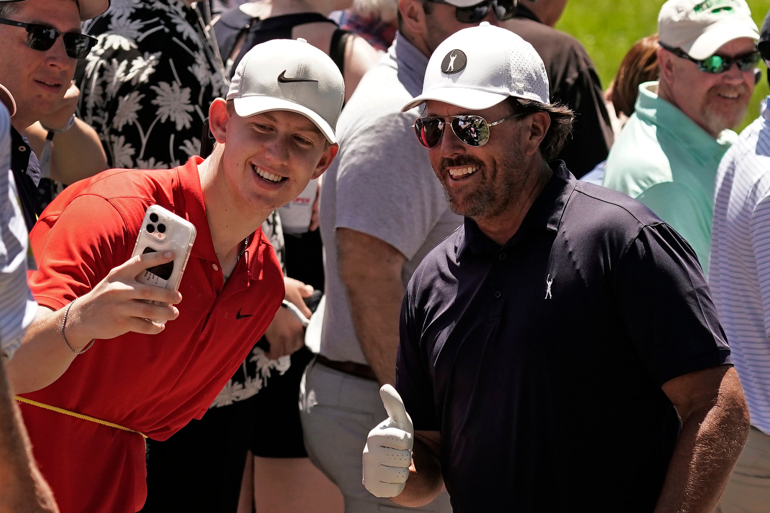 Phil Mickelson poses for a photo with a fan during a practice round ahead of the US Open at Brookline (Charlie Riedel/AP)