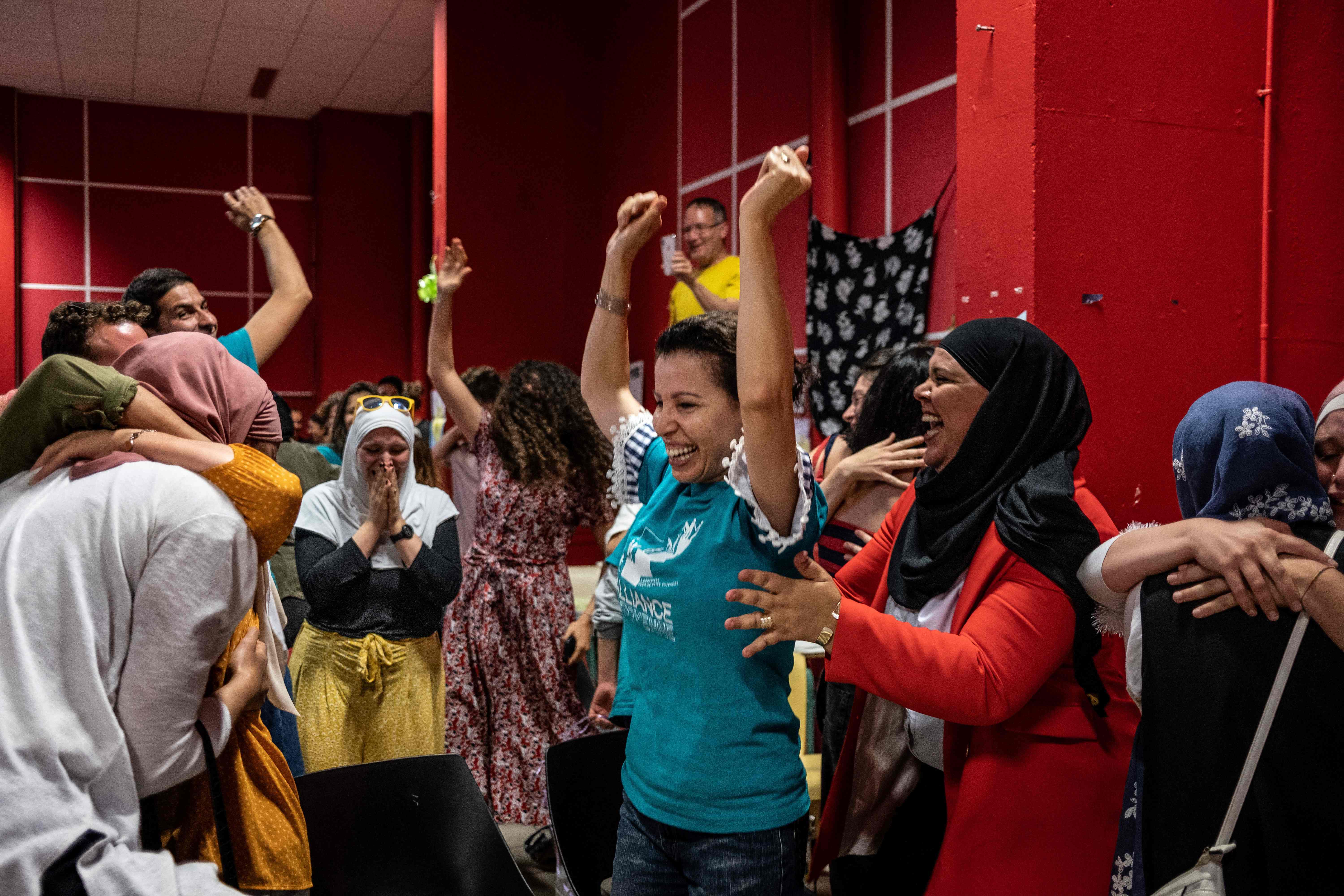 Members of the pro-burkini association celebrate after members of Grenoble municipal council voted to allow the wearing of the burkini in the city's swimming pools