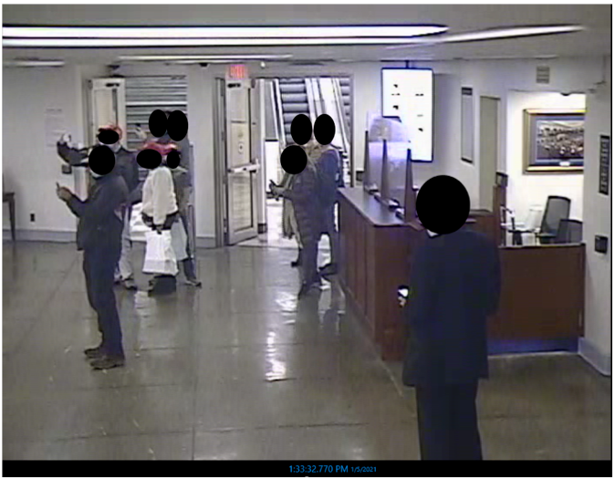 Tour group members shoot photos of a tunnel connecting the Rayburn House Office Building to the Capitol on 5 January 2021
