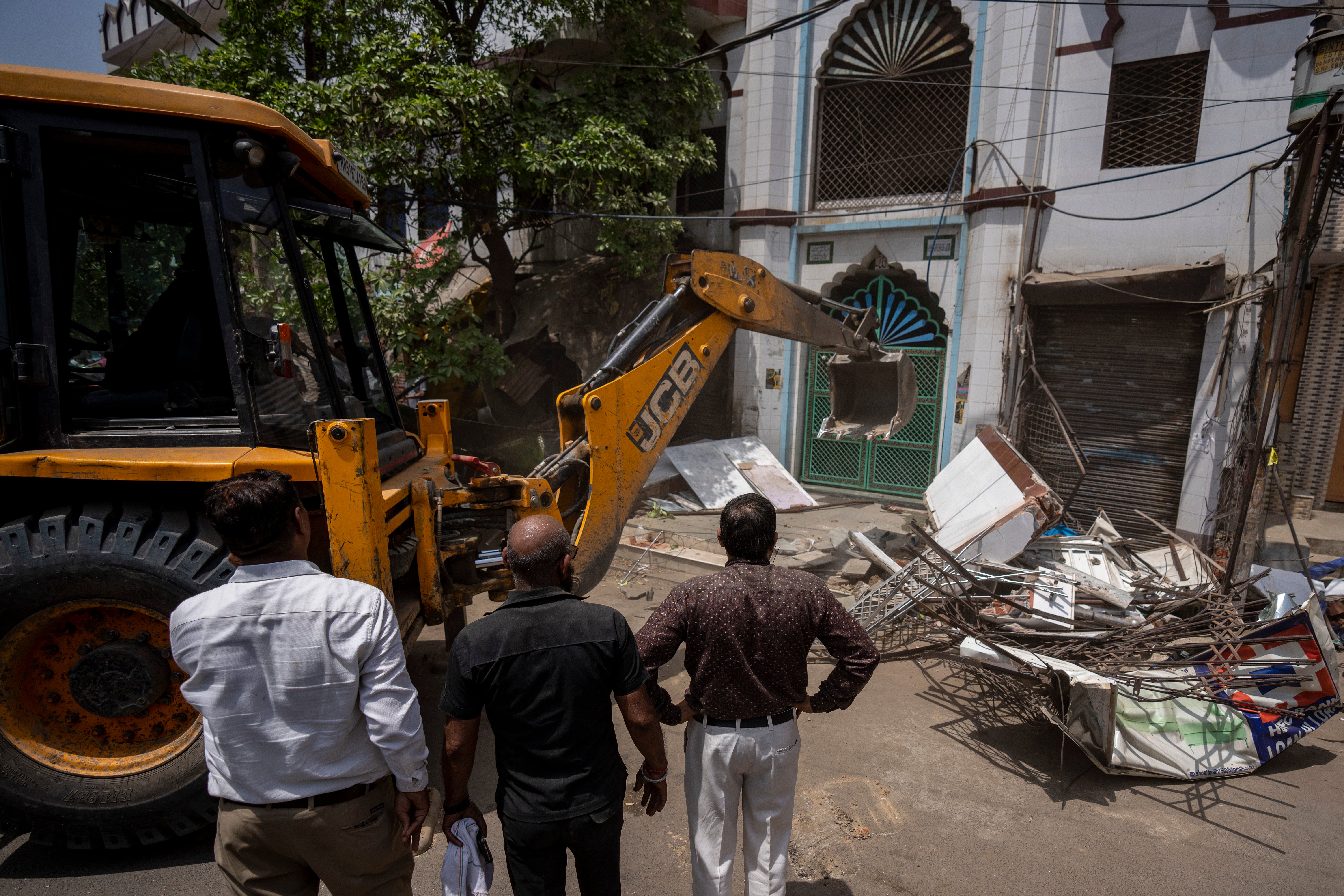 JCB machines seen razing the wall of a mosque in Delhi’s Jahangirpuri on 20 April