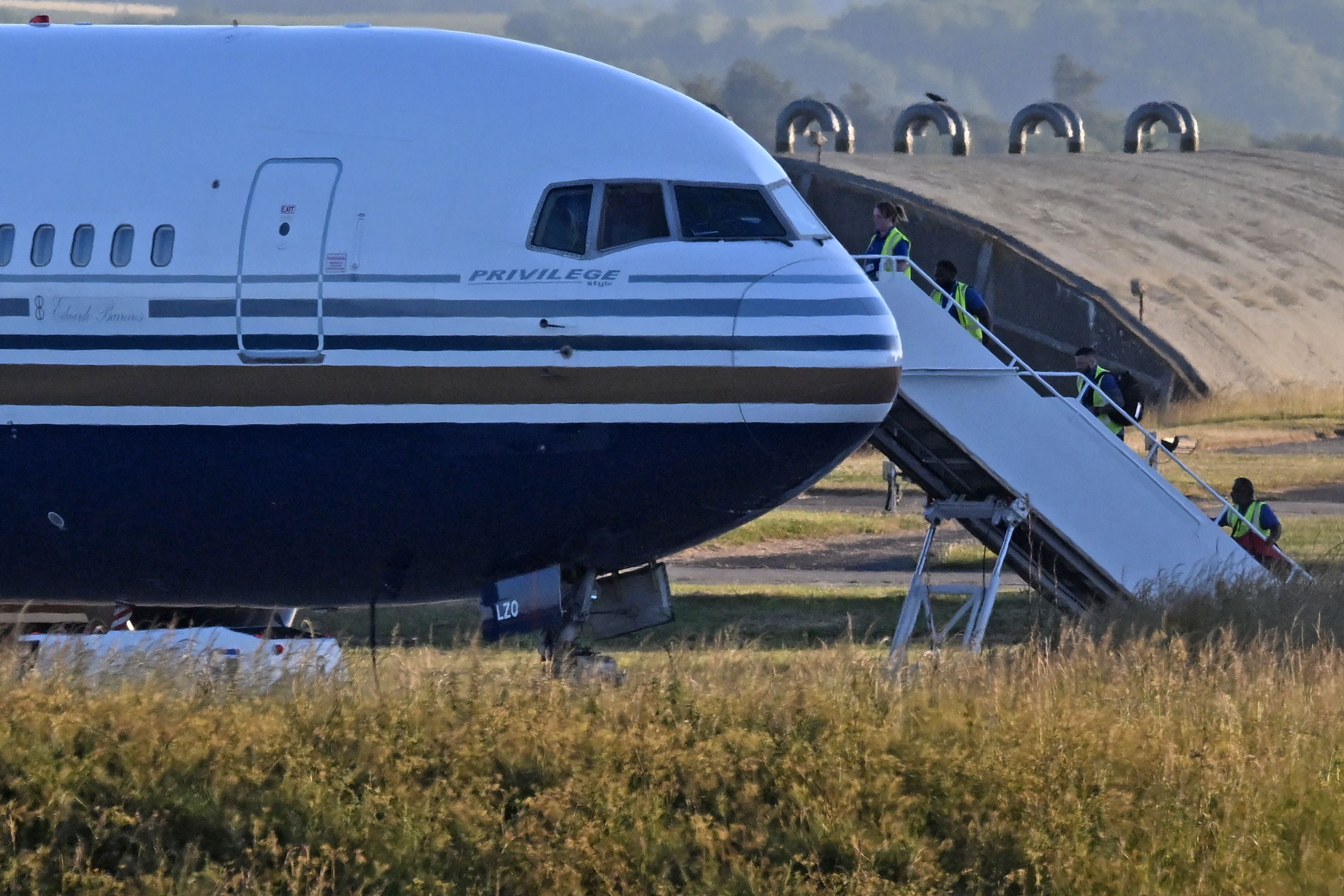 A Boeing 767 sits on the runway at the military base in Amesbury, Salisbury, preparing to take a number of asylum-seekers to Rwanda