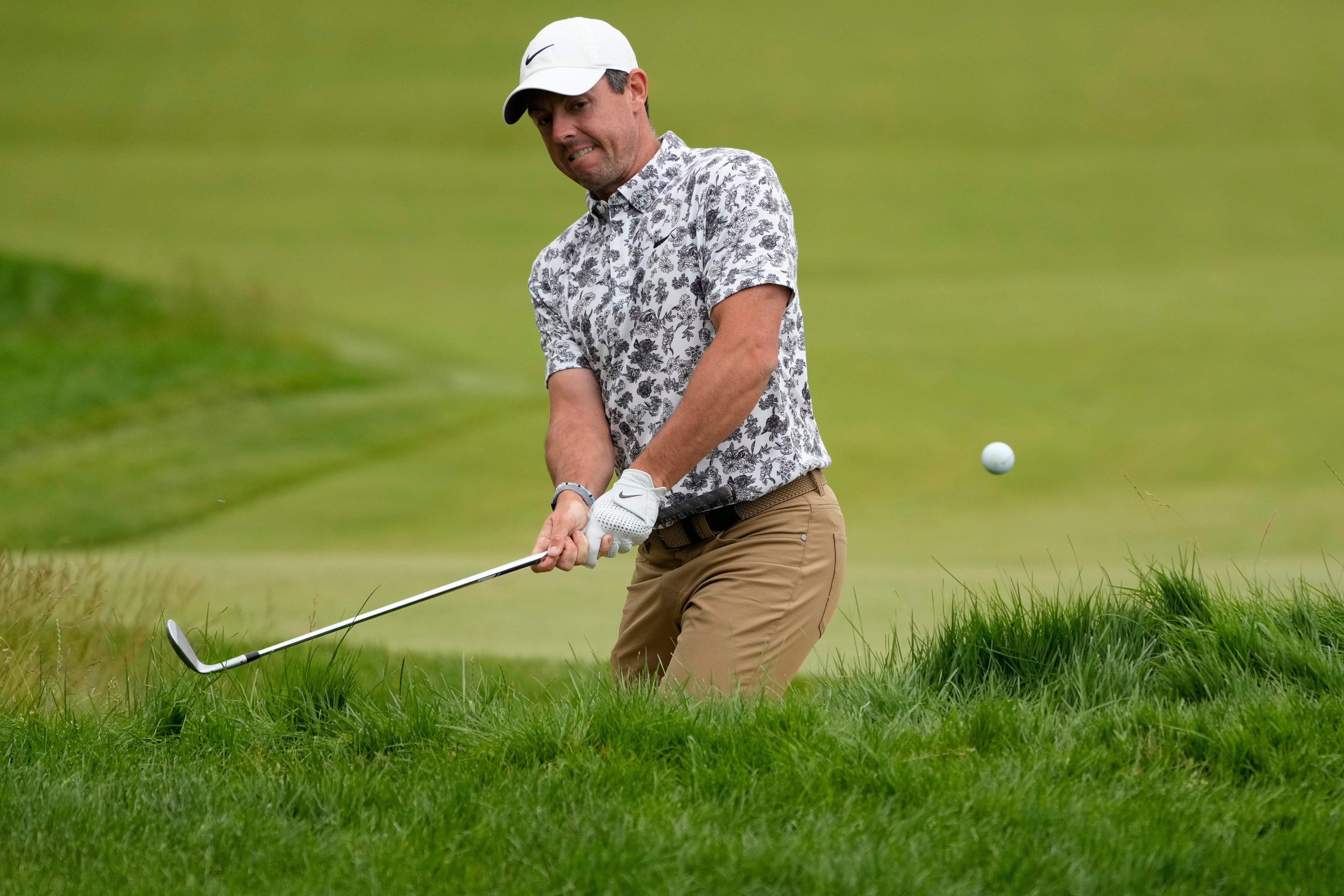 Rory McIlroy hits his second shot on the fifth hole during the first round of the US Open (Charles Krupa/AP)