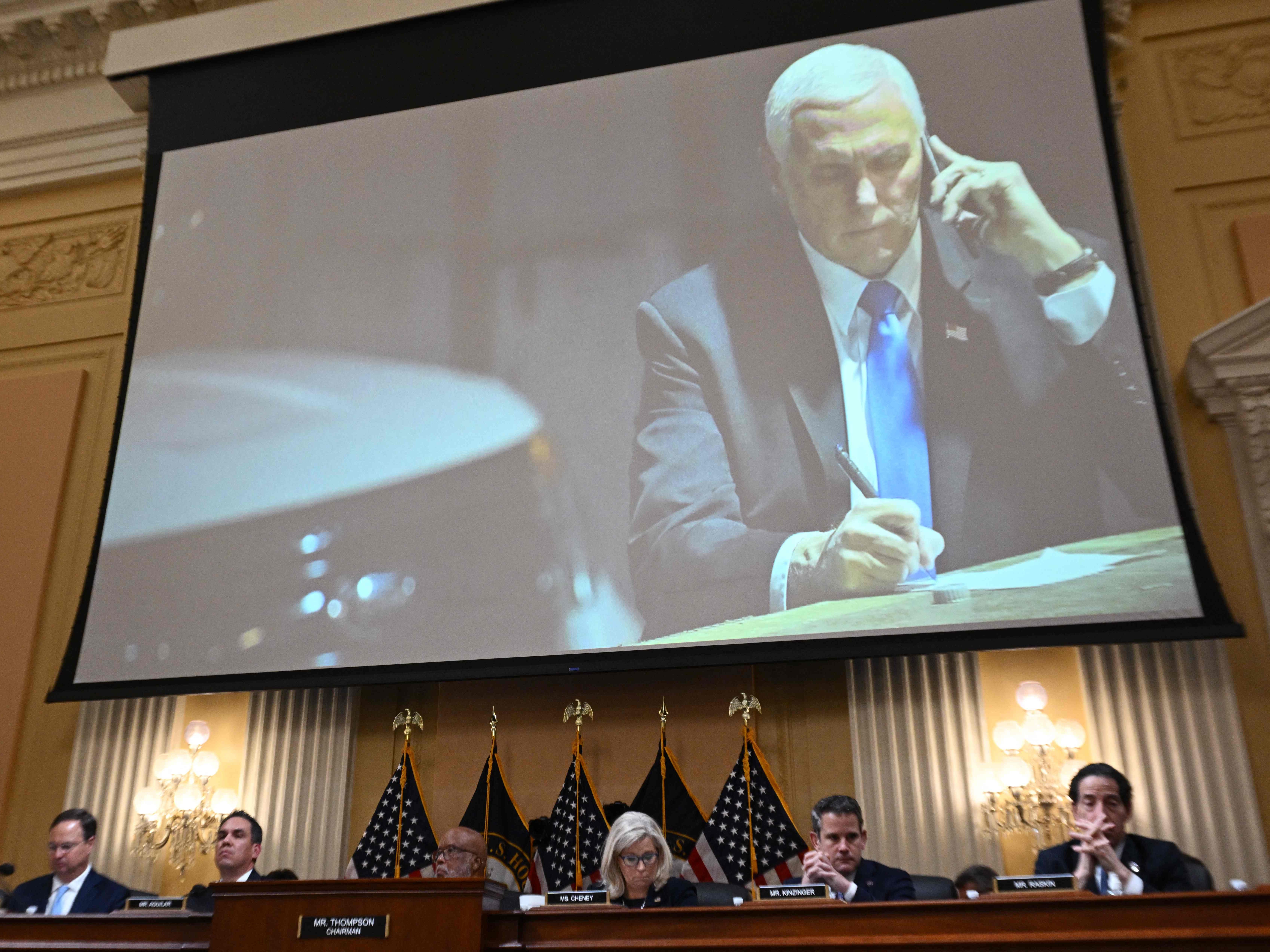 An image on a screen shows former US Vice President Mike Pence looking at his phone as he shelters in a secure underground location after being evacuated from the Senate chamber on January 6, 2021