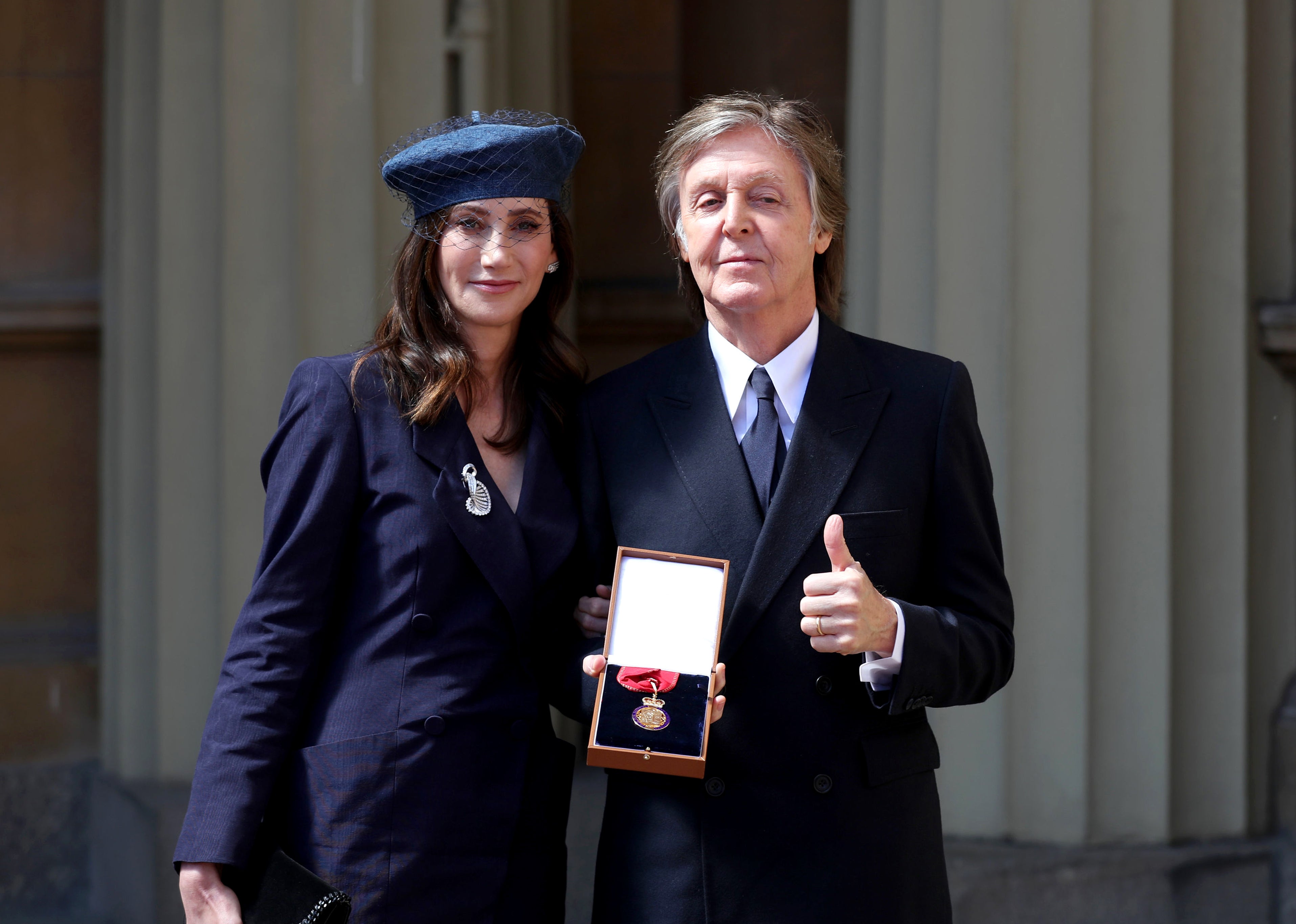 Sir Paul McCartney and his wife Nancy Shevell after he was made a Companion of Honour (Steve Parsons/PA)