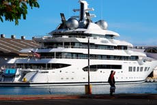 Seized Russian superyacht docks in Hawaii waving US flag