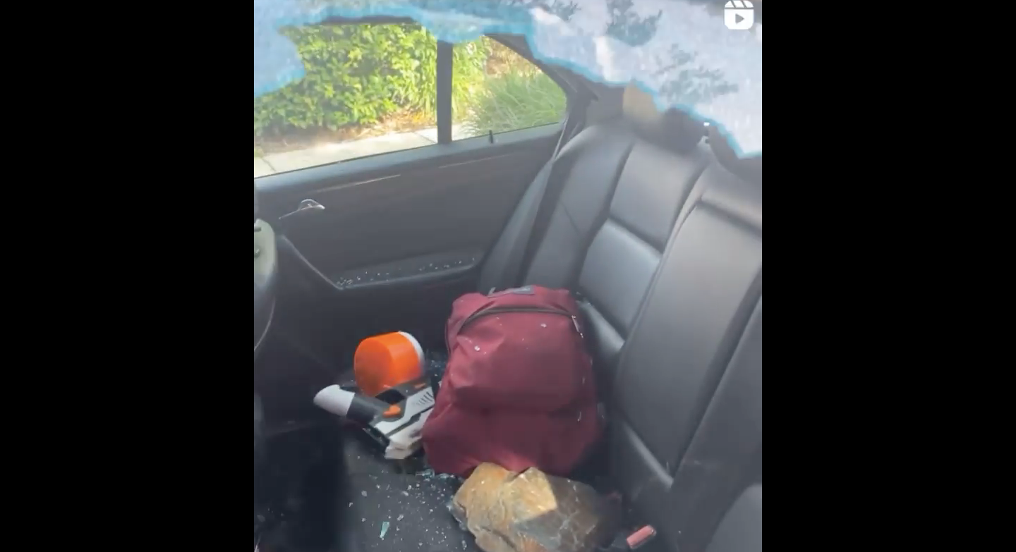 The rock that was thrown at the 16-year-old’s car is seen in the backseat of his car, surrounded by shards of glass from his broken window