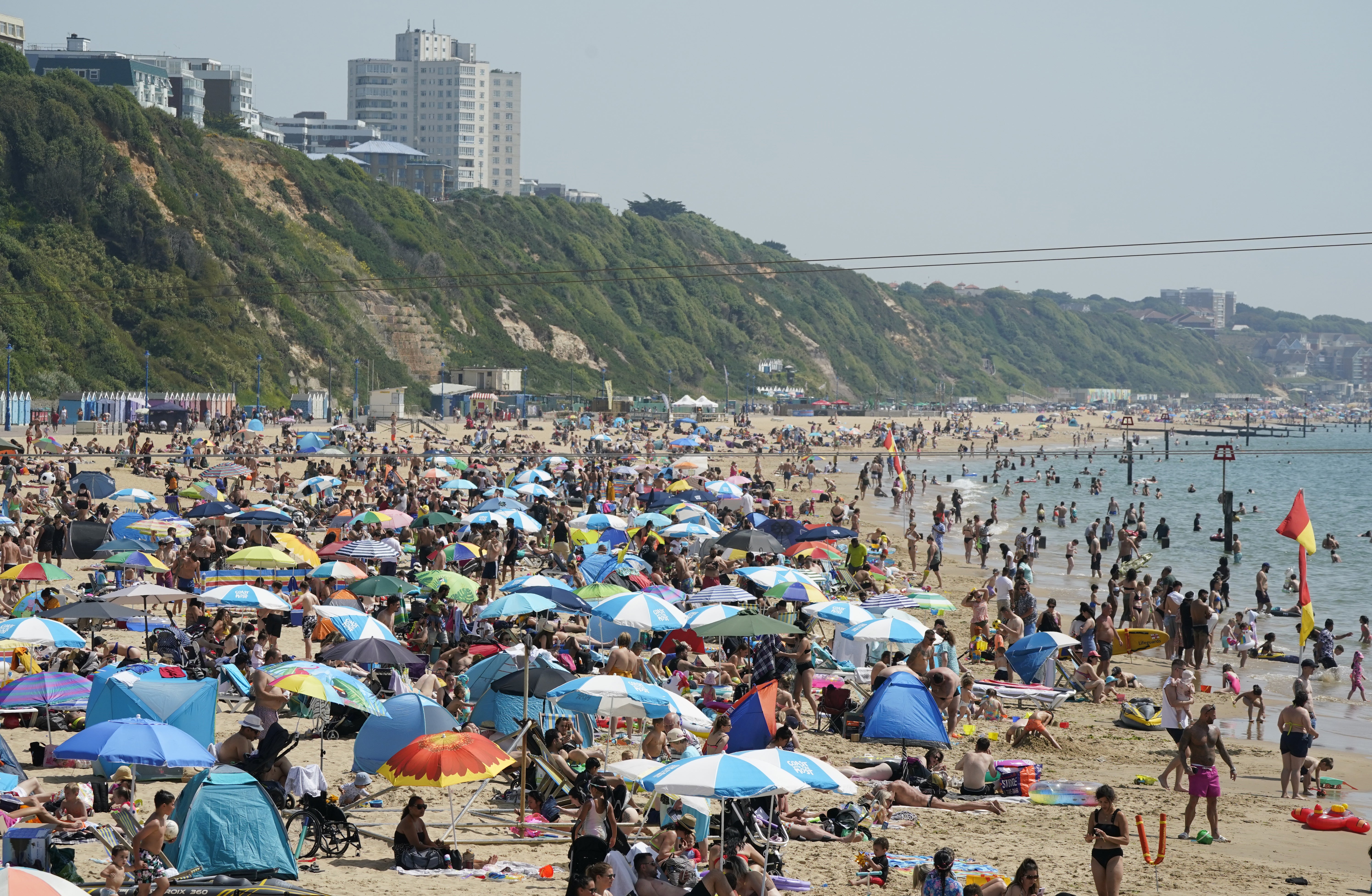 People enjoy the warm weather on Bournemouth beach in Dorset (Andrew Matthews/PA)