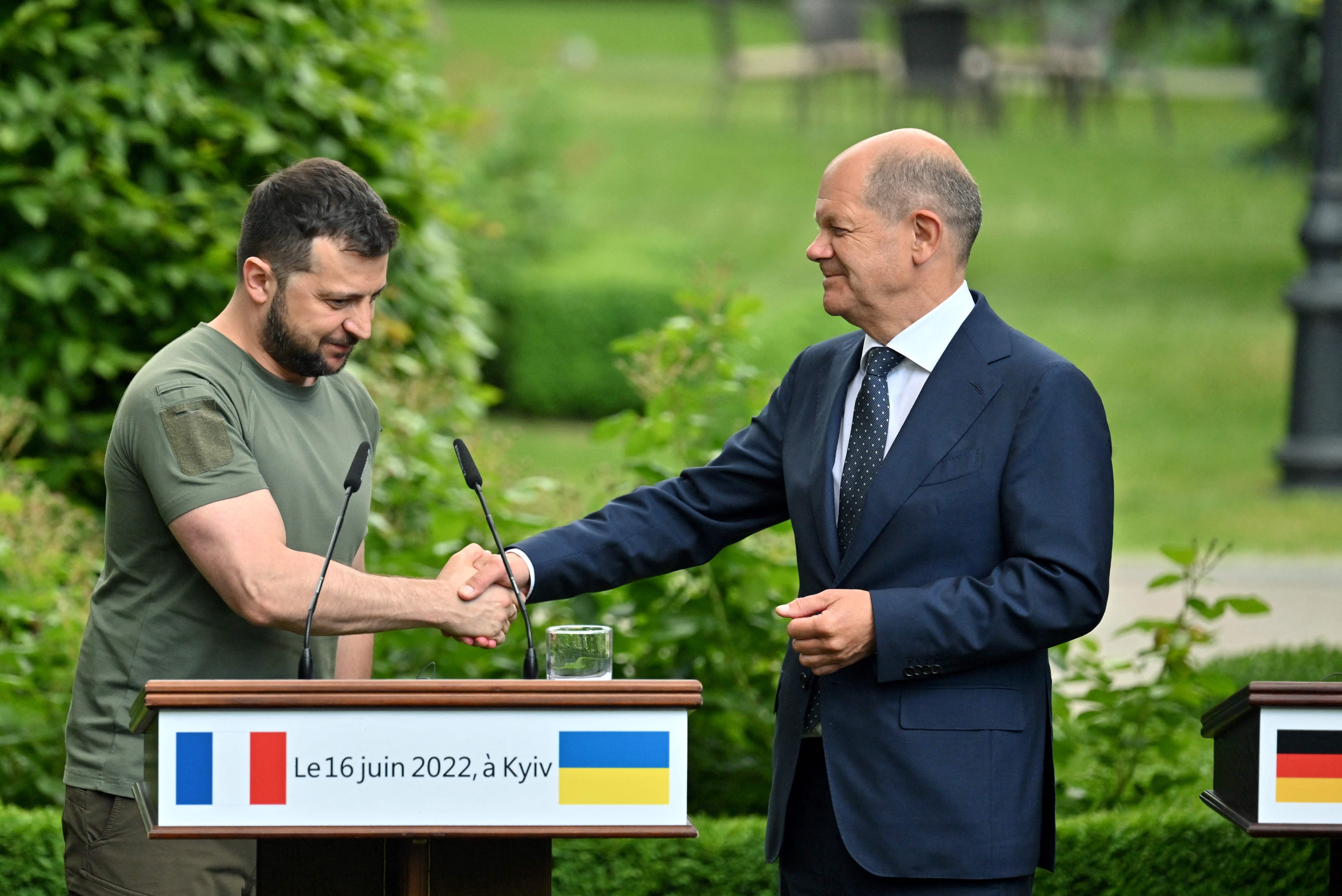 Ukrainian President Volodymyr Zelensky and Chancellor of Germany Olaf Scholz shake hands