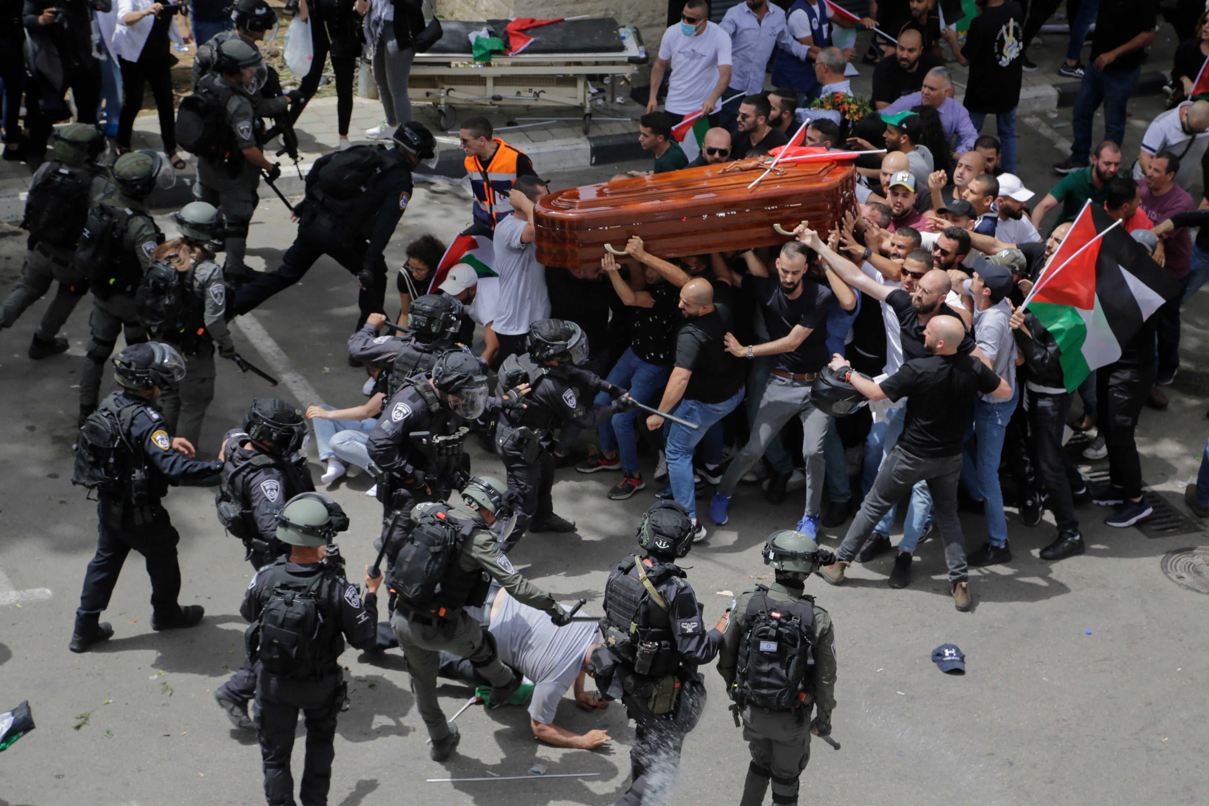 Israeli police attack mourners as they carry the casket of Al Jazeera journalist Shireen Abu Akleh