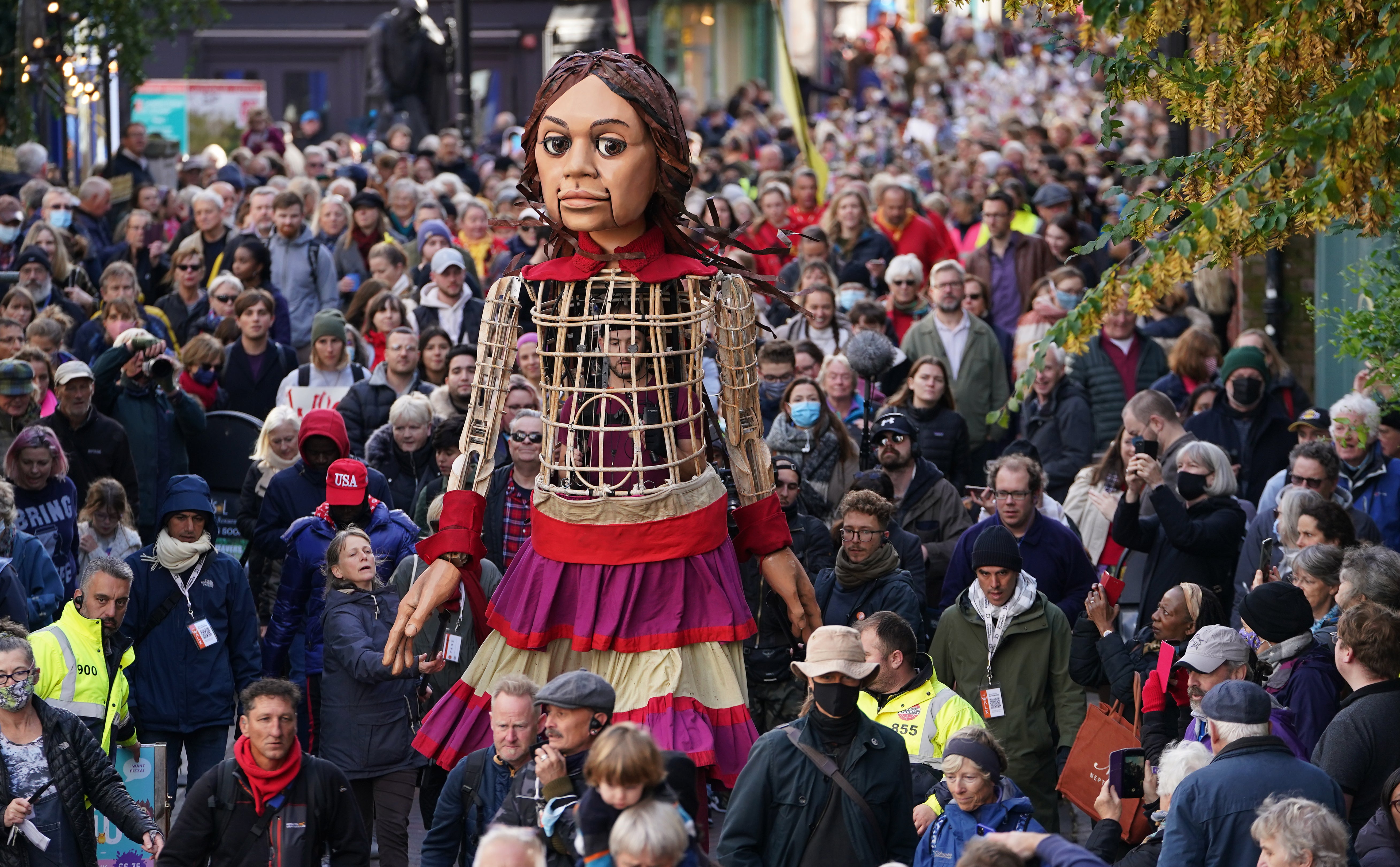 A giant puppet of a 10-year-old Syrian refugee has embarked on a tour of England, visiting landmark destinations to take part in World Refugee Week (PA)