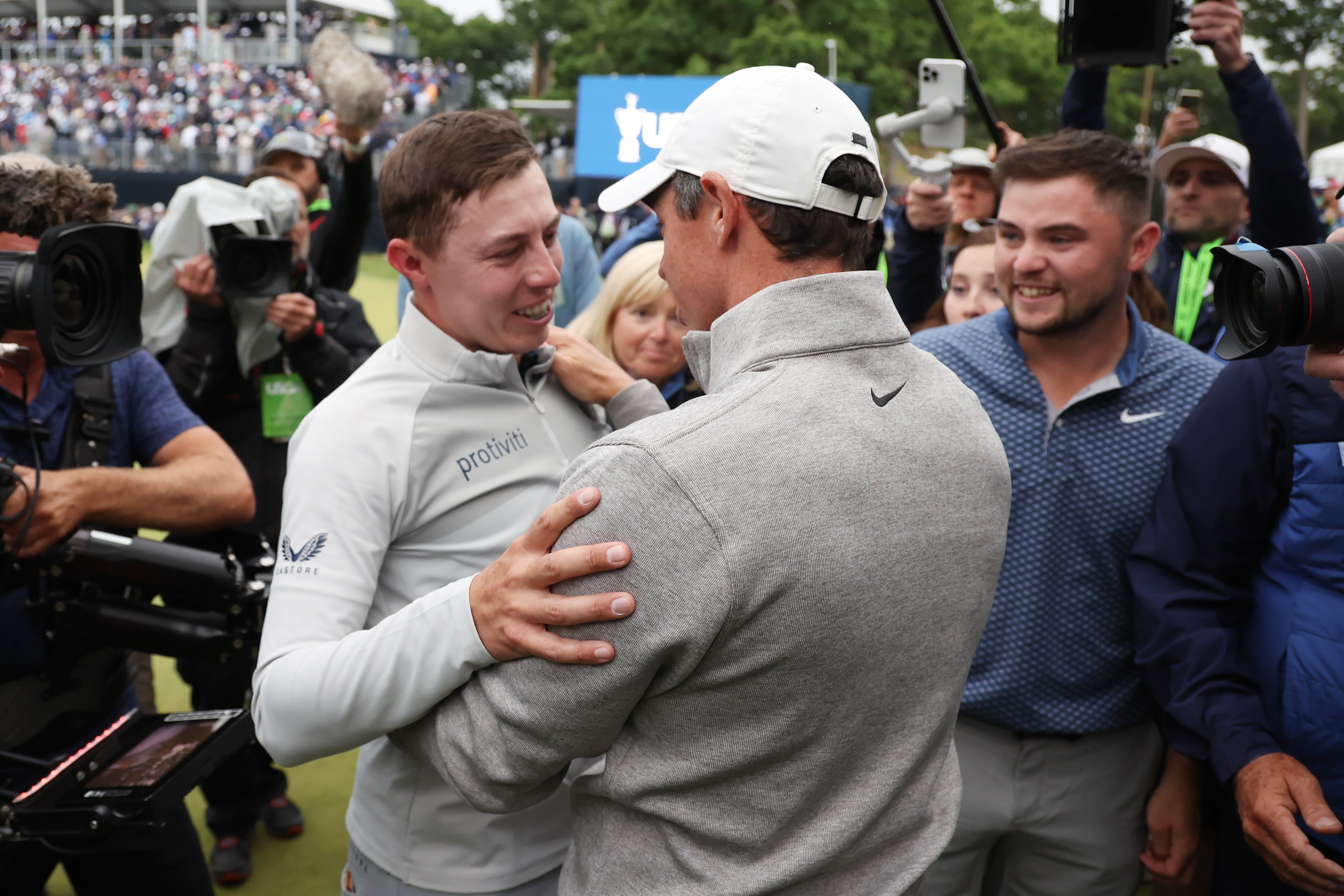 Matt Fitzpatrick is embraced by Rory McIlroy on the 18th green