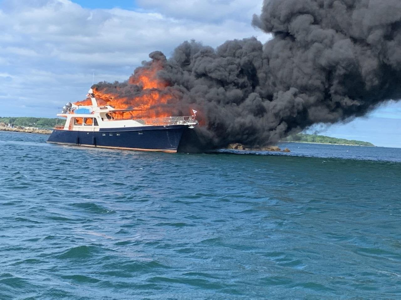 Smoke is seen stretching across the water near New Castle in New Hampshire on Saturday afternoon after a yacht caught fire