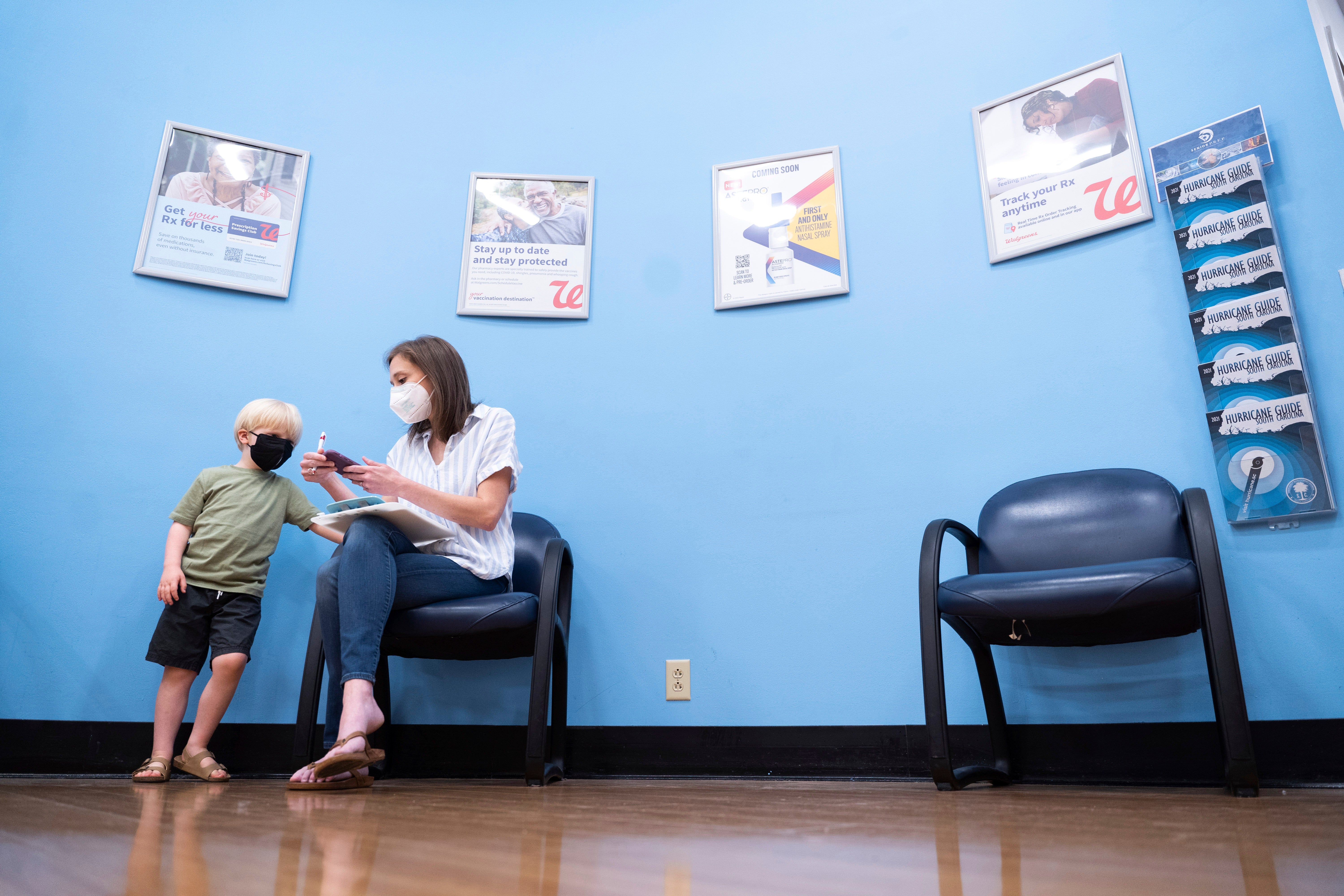 Three year-old Fletcher Pack watches as his mother, McKenzie Pack, fills out paperwork prior to receiving the Moderna Covid-19 vaccination in Lexington, South Carolina