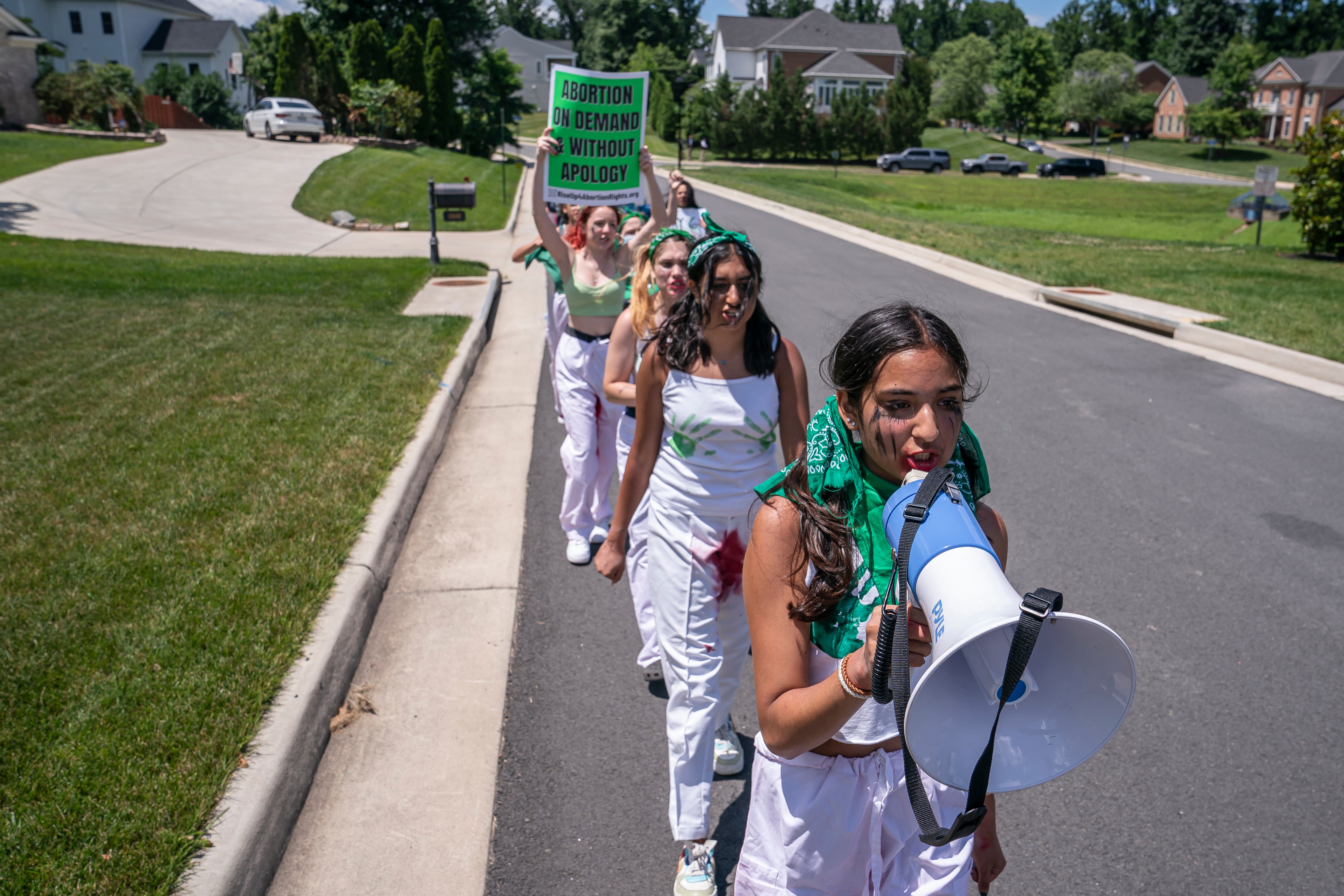 Abortion-rights activists march near the home of Supreme Court Justice Amy Coney Barrett