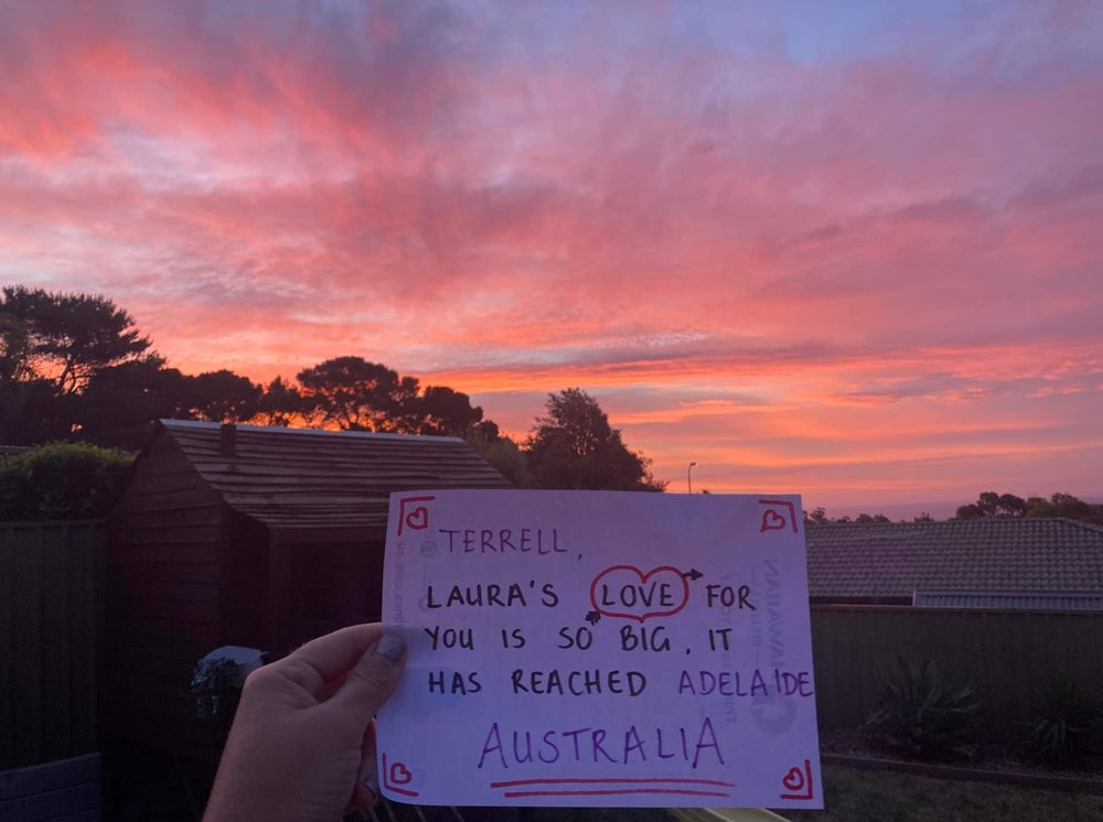 Laura O’Sullivan, 32, shows Terrell how much she loves him by asking people across the world to hold up pieces of paper with love notes on them (Collect/PA Real Life)