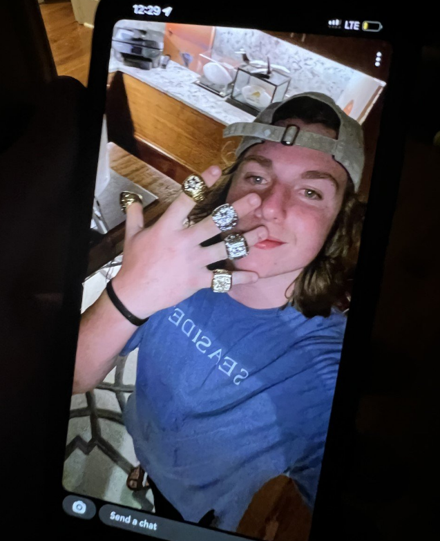 An image shared by the WSCO on Facebook shows a teen flaunting what appears to be championship rings inside the Florida home