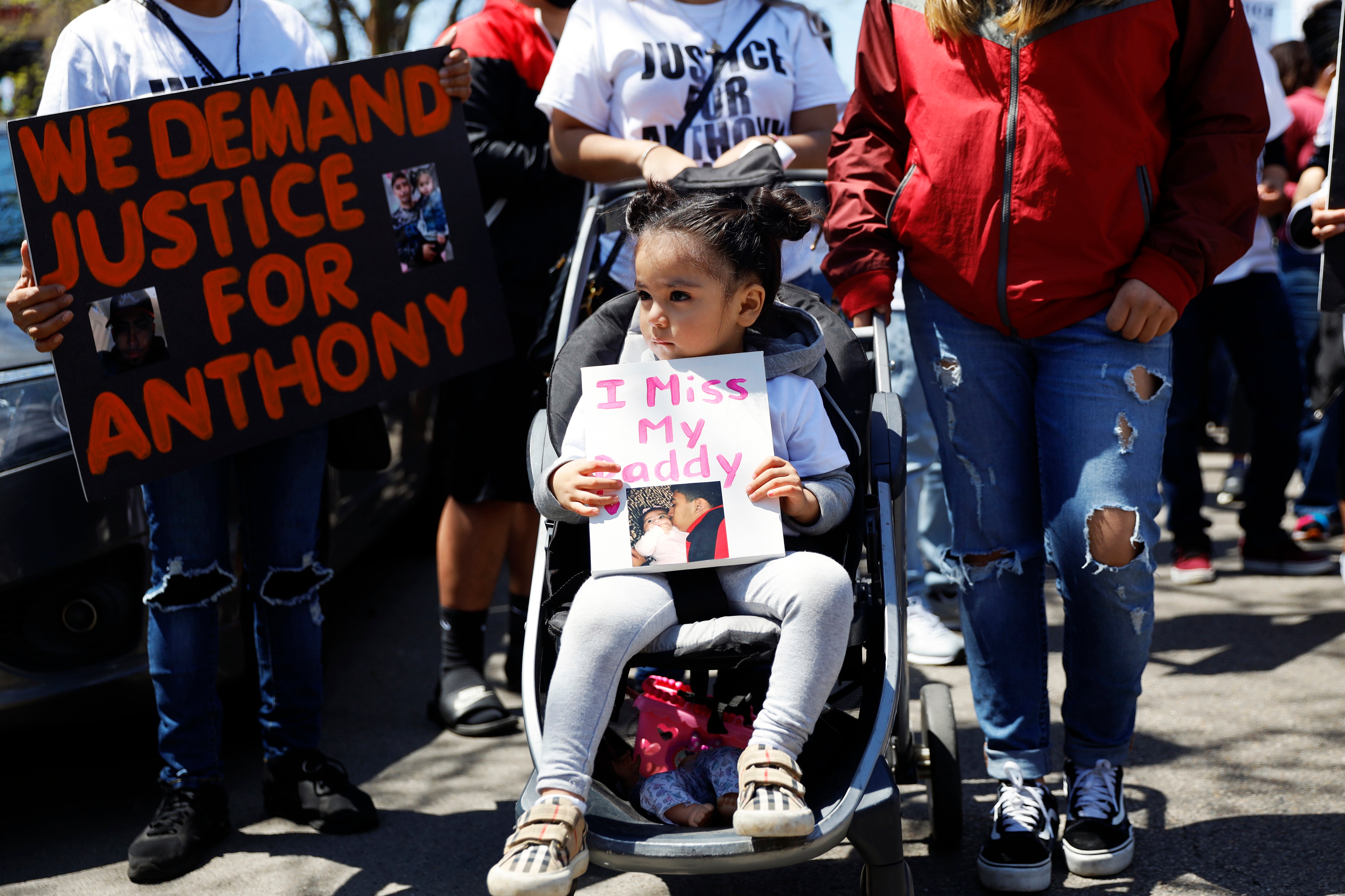 Ailani Alvarez, 2, daughter of Anthony Alvarez who was shot by the police, holds a sign reading ‘I miss my daddy’ during a 2021 protest in Chicago