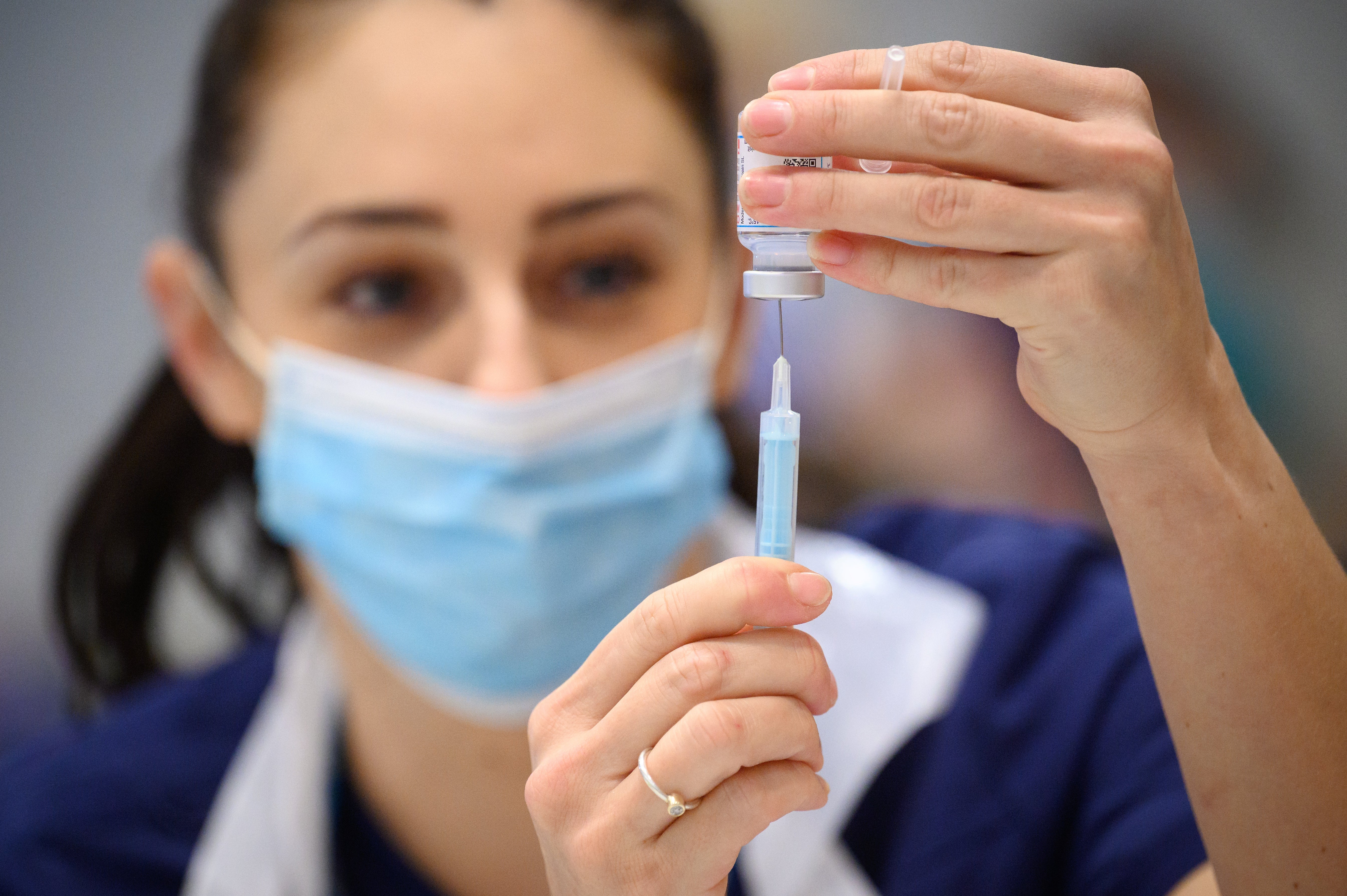 Medical staff and volunteers prepare shots of the Moderna Covid-19 vaccine (PA)