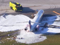 Plane carrying 126 people catches fire after landing gear collapses on Miami runway