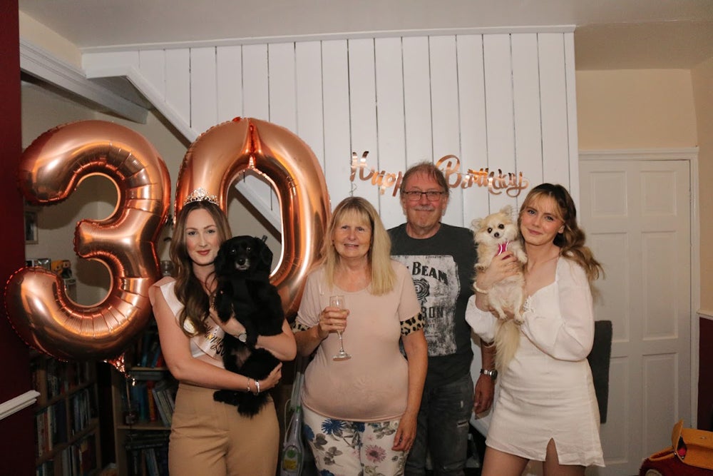 Laura celebrating her 30th birthday with her parents and sister eight months after her cancer op (PA Real Life/Collect)