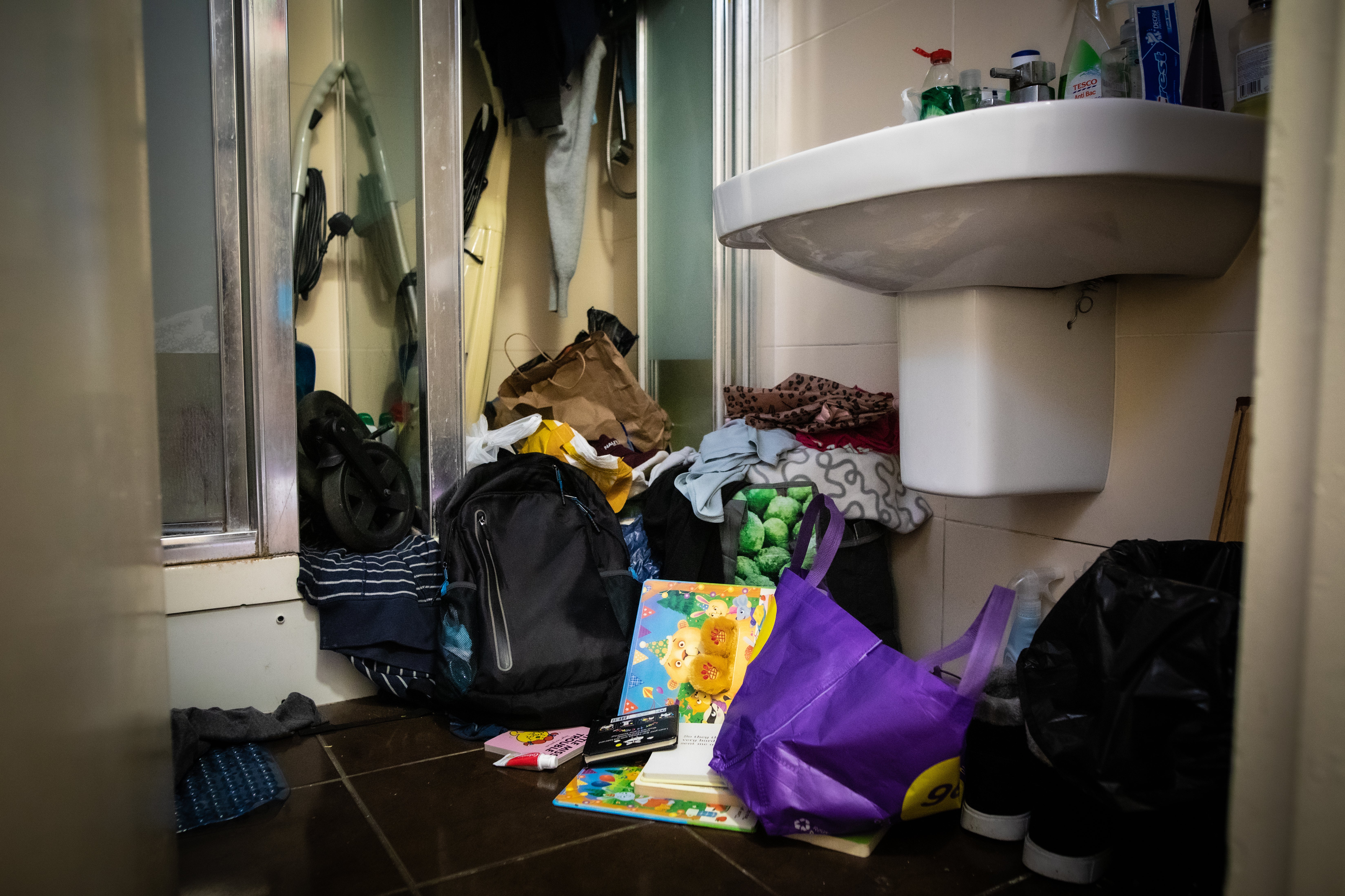 Carlos and Aline’s bathroom is cluttered with belongings as they have no proper storage