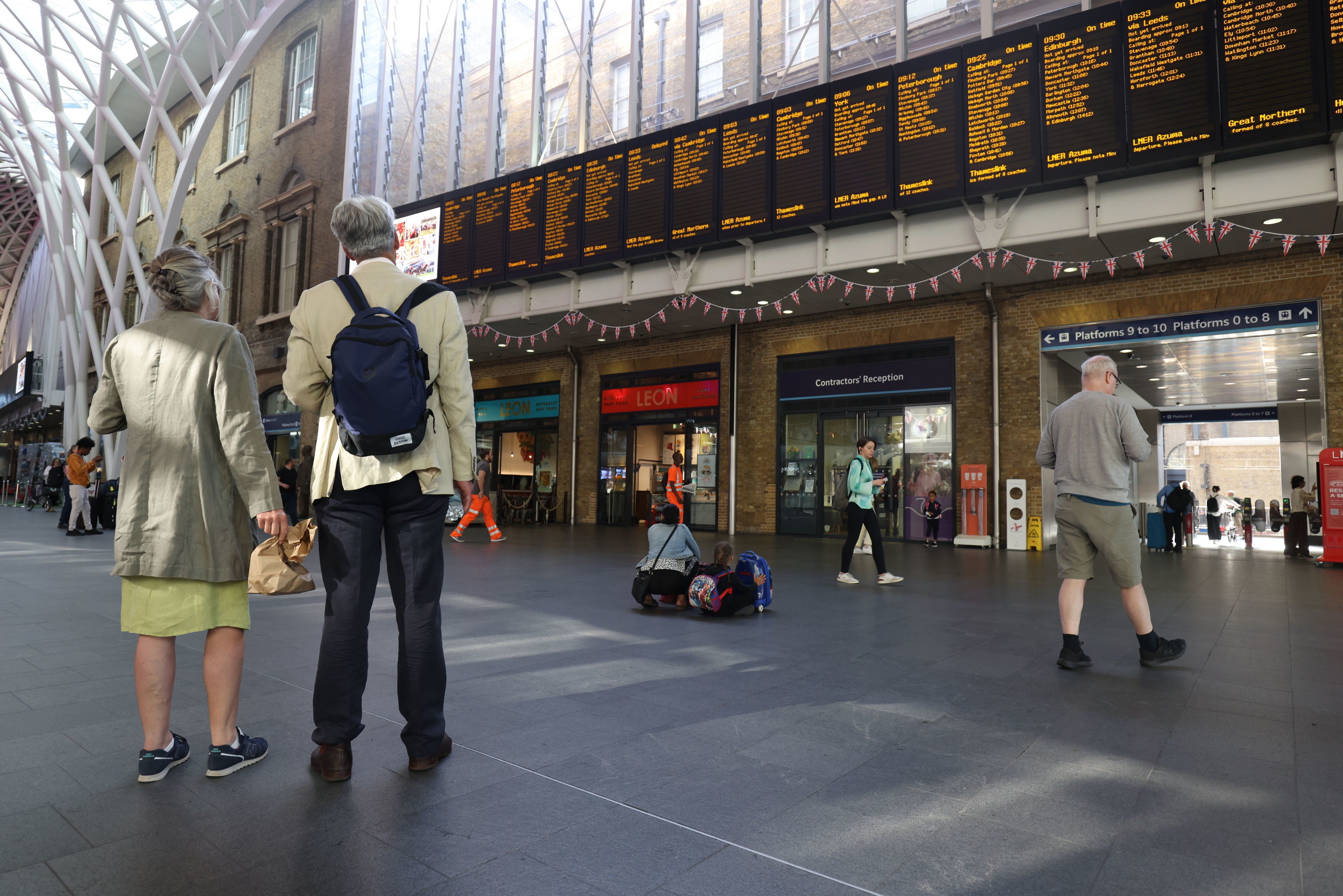 Passengers are seen at King’s Cross St. Pancras station in London, as train services continue to be disrupted following strike action