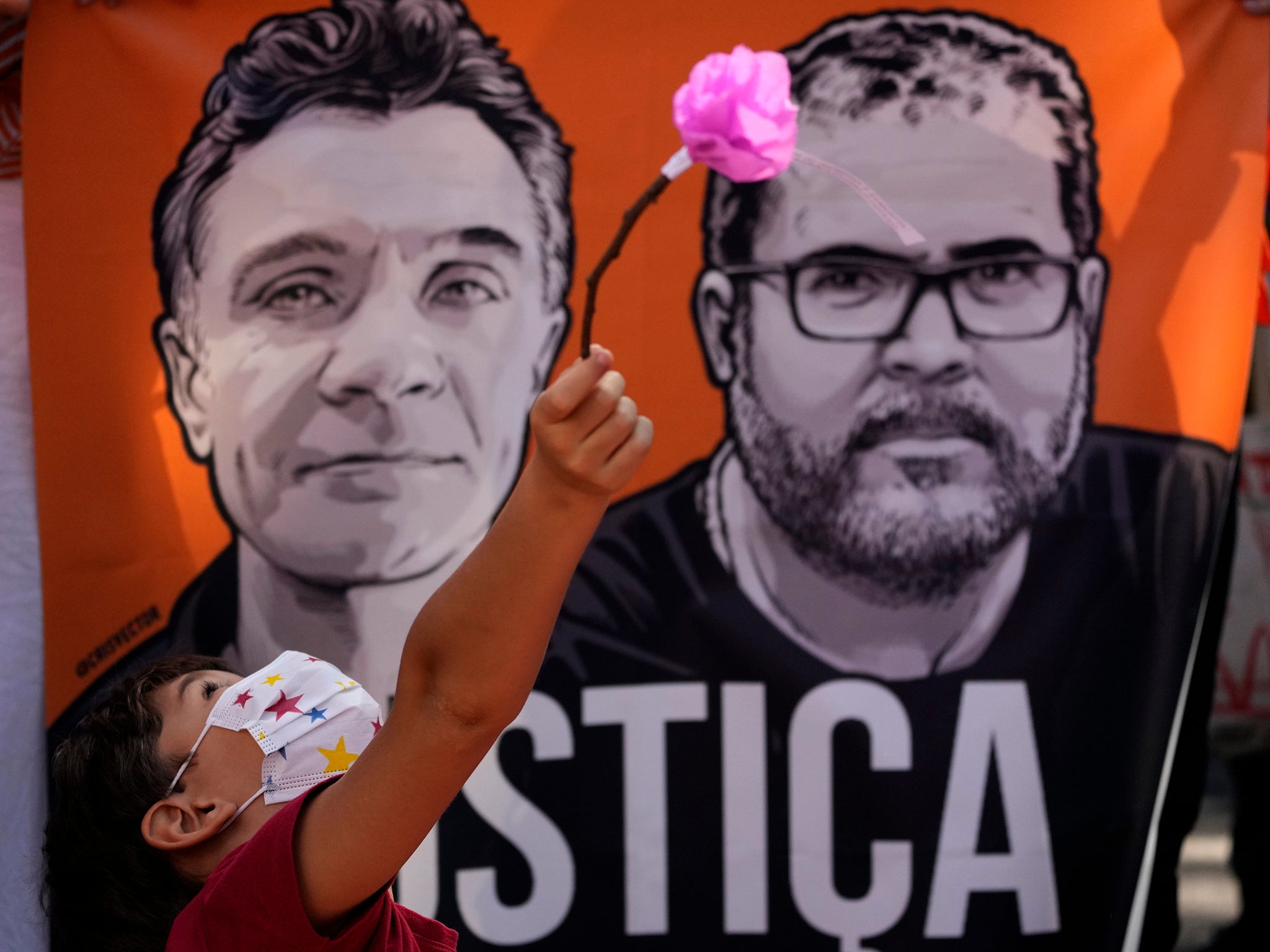 A banner with images of Phillips (left) and Bruno Pereira and the word ‘Justice’ written in Portuguese, during a rally demanding authorities conduct a thorough investigation into the circumstances leading to their deaths, in Brasilia on 19 June