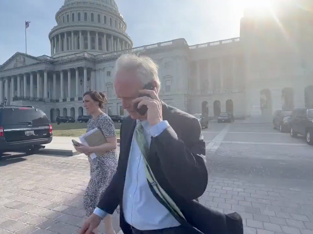 Wisconsin Senator Ron Johnson pretends to be on the phone as he leaves the Capitol on 21 June 2022