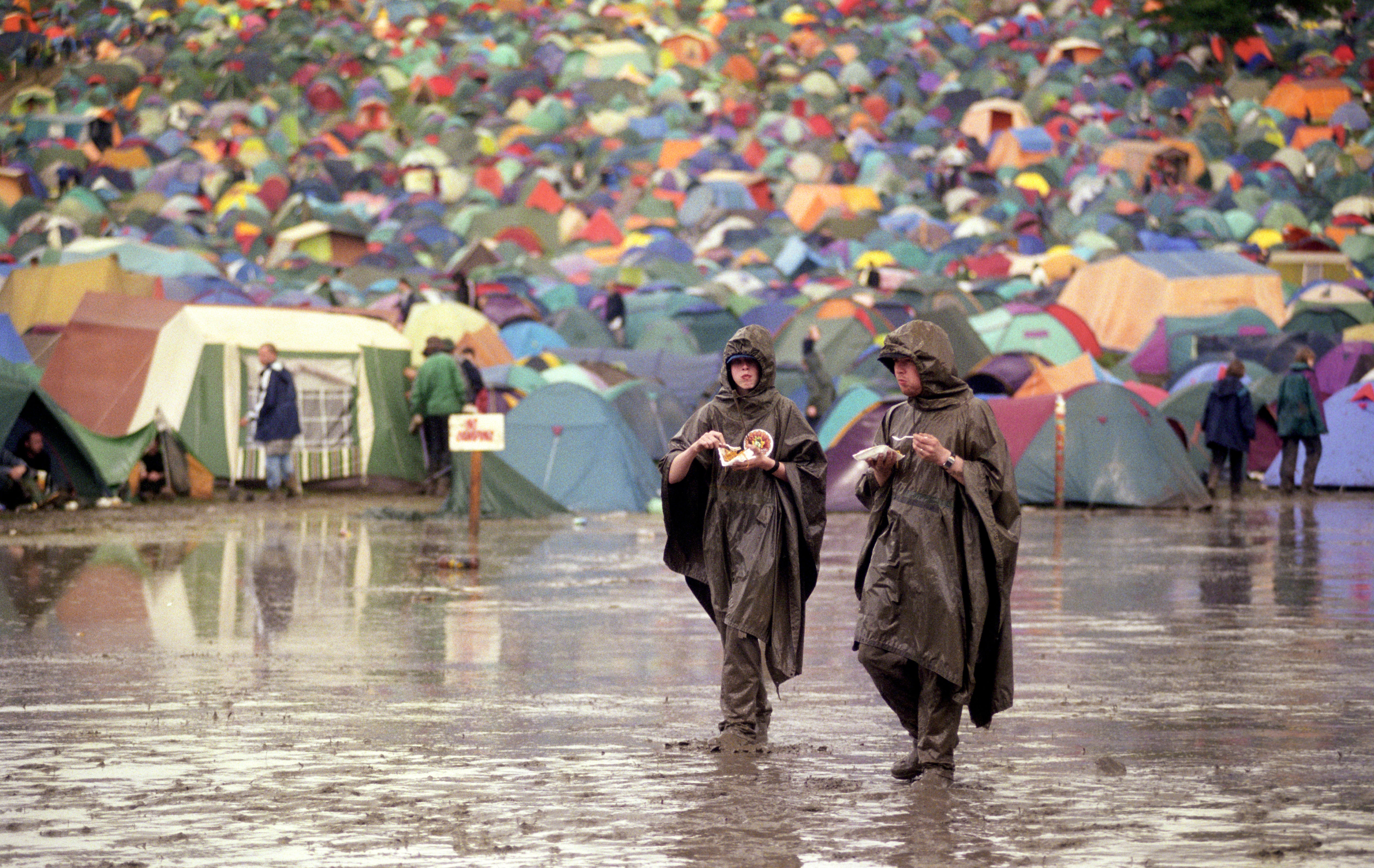 Two festival-goers enjoy a pizza in 1998