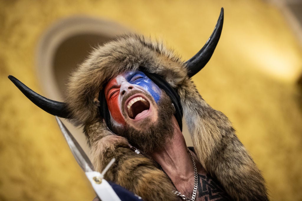 The QAnon Shaman aka Jacob Chansley inside the Senate chamber during the Jan 6 Capitol riot