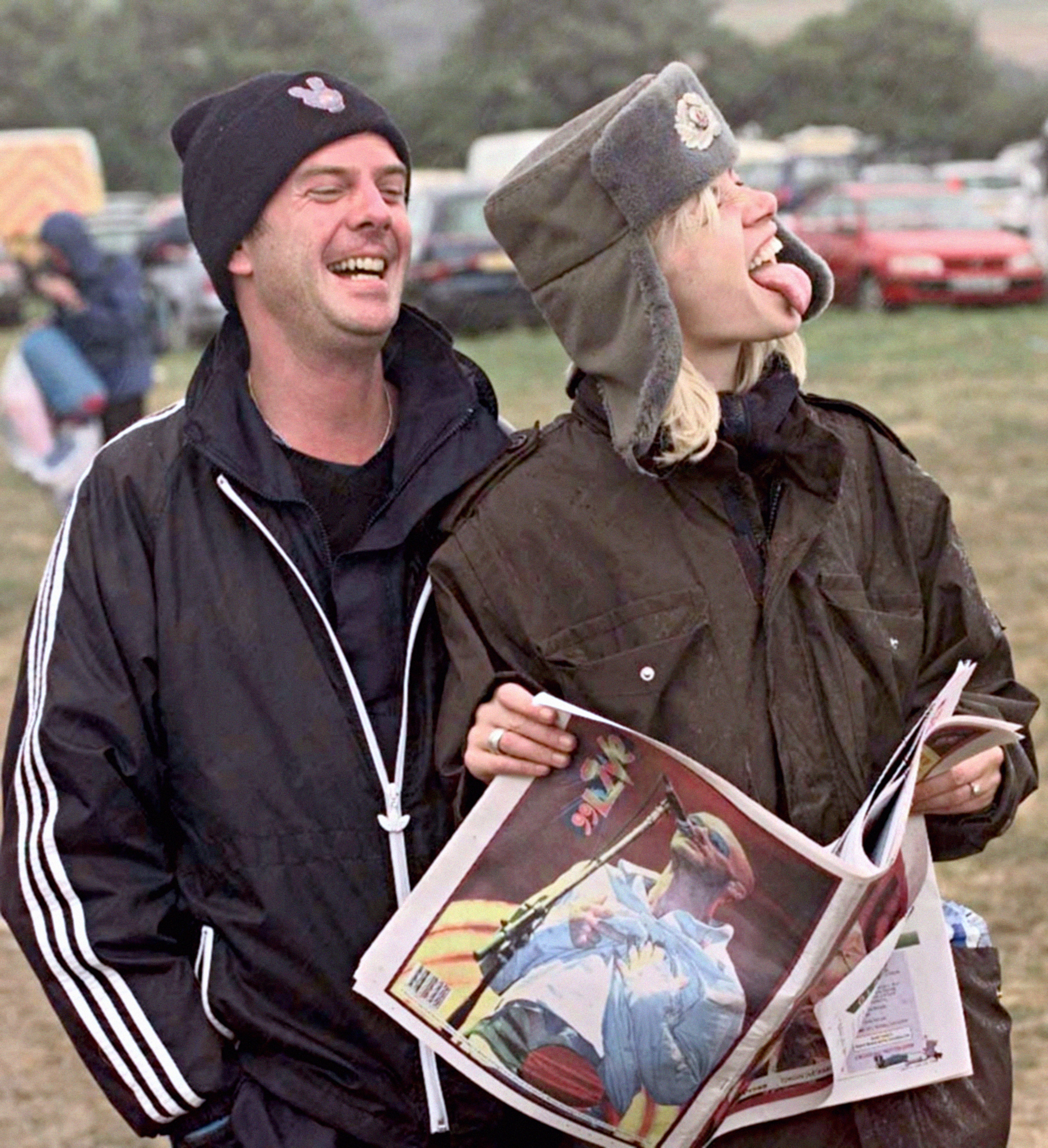 Norman Cook aka Fatboy Slim laughs at his fiance, radio and television presenter Zoe Ball (right), as the weather takes a turn for the worse in 1999