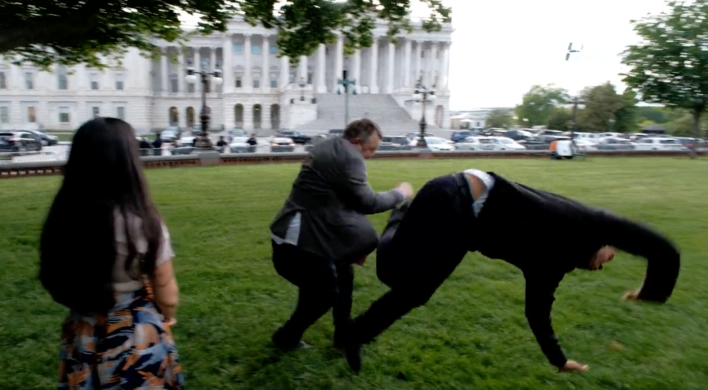 Senator Jon Tester is seen jokingly tackling Senator Cory Booker in a recent political ad