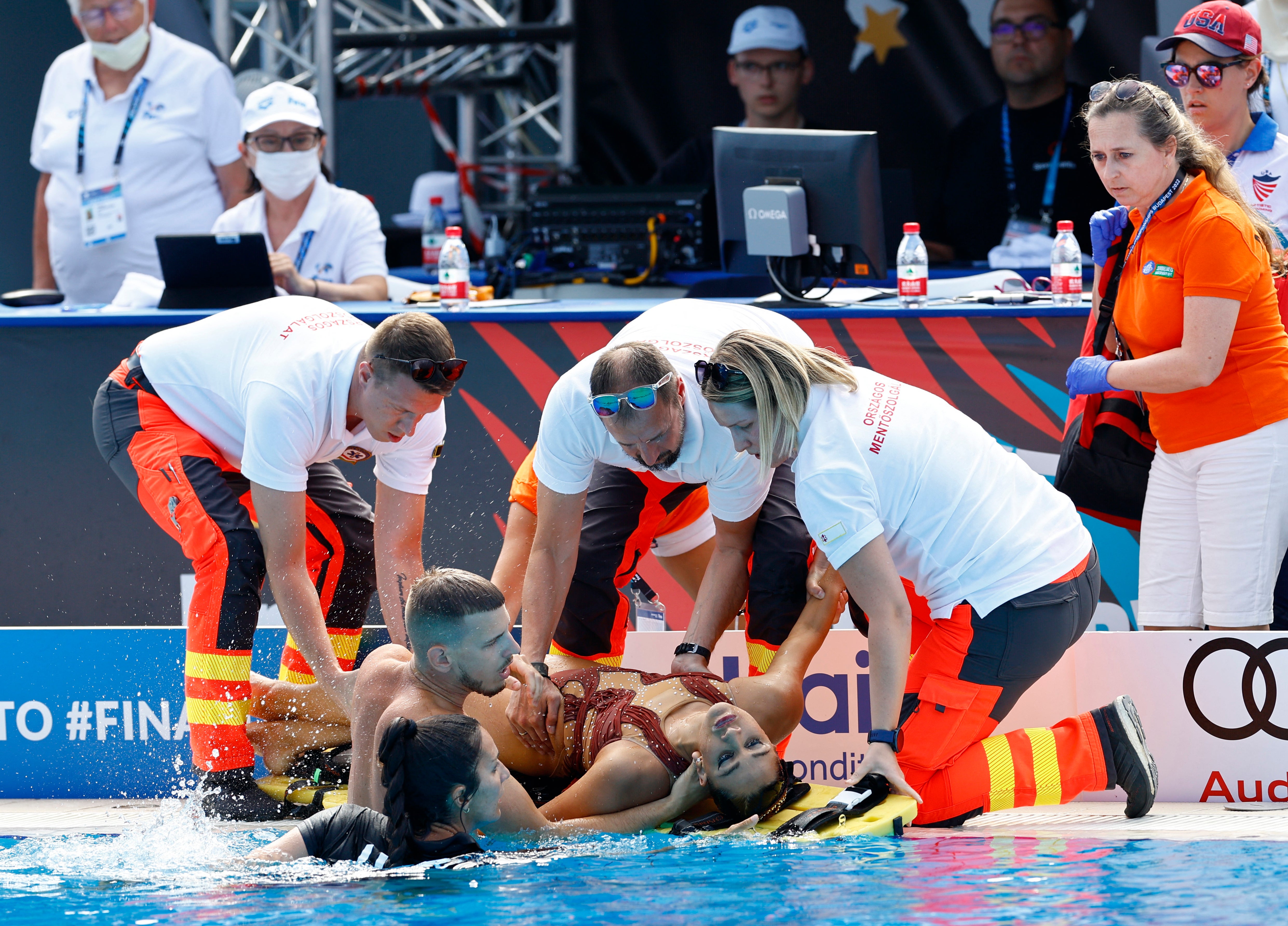 Alvarez is placed on to a stretcher poolside