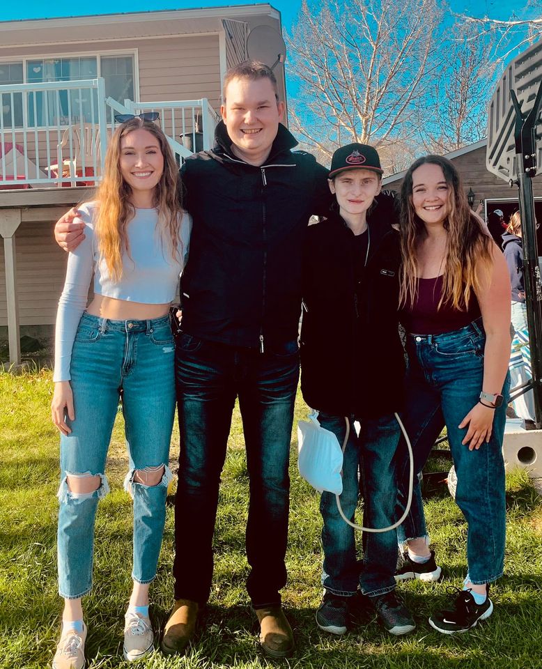 Eric Coulam, centre, poses with his friends at the celebration of life held at his father’s home in Fort St John, BC on 21 May