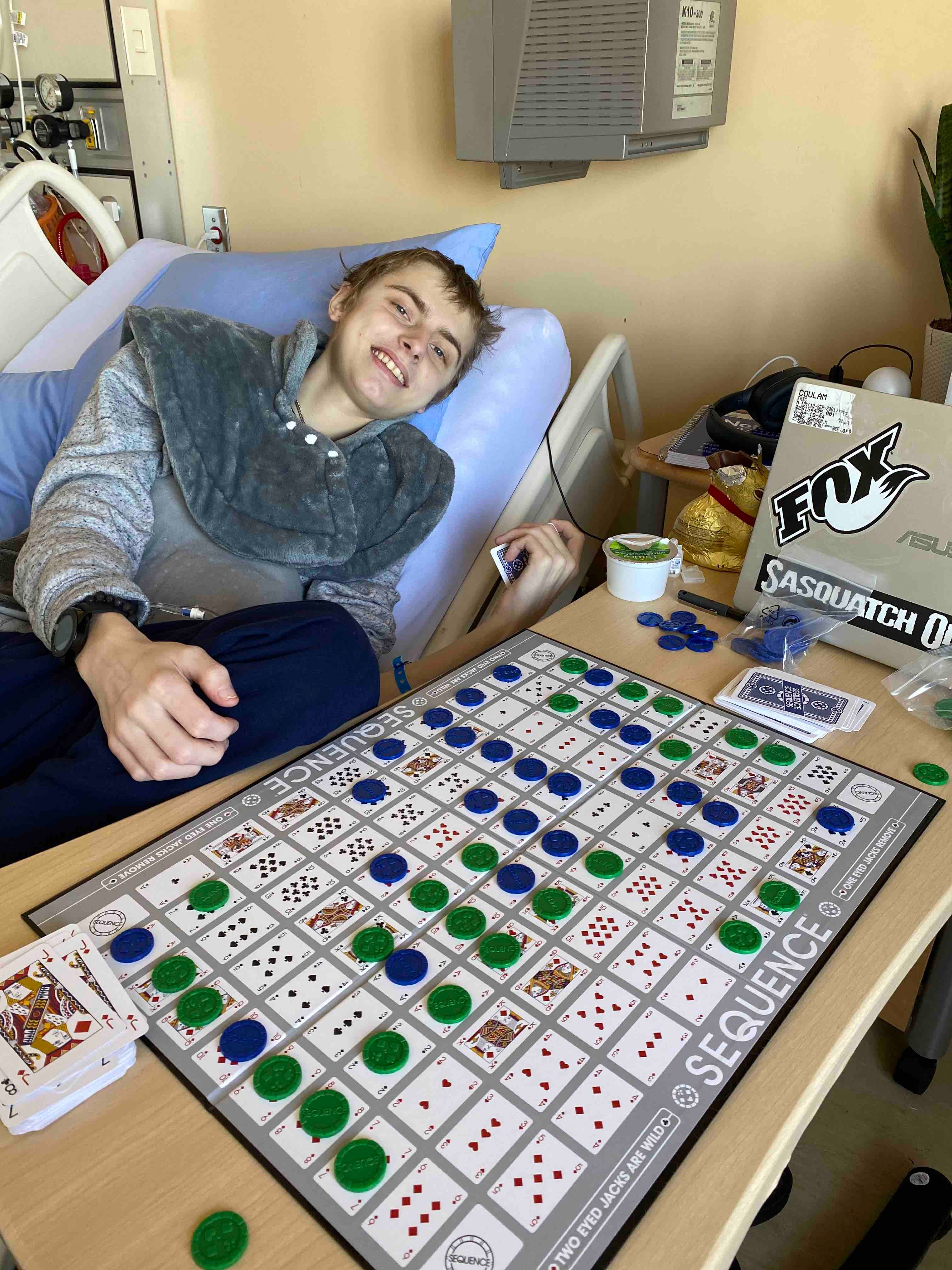 Eric Coulam plays a board game in a British Columbia hospital