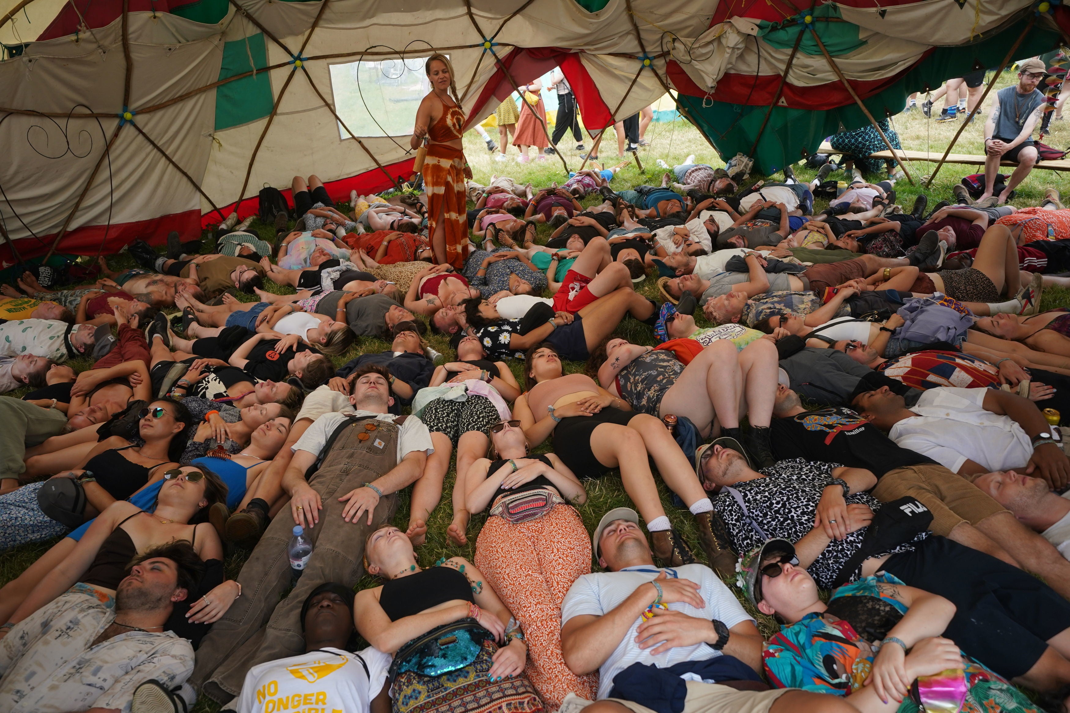 Festival-goers take part in a laughter - yoga workshop in the Healing Field