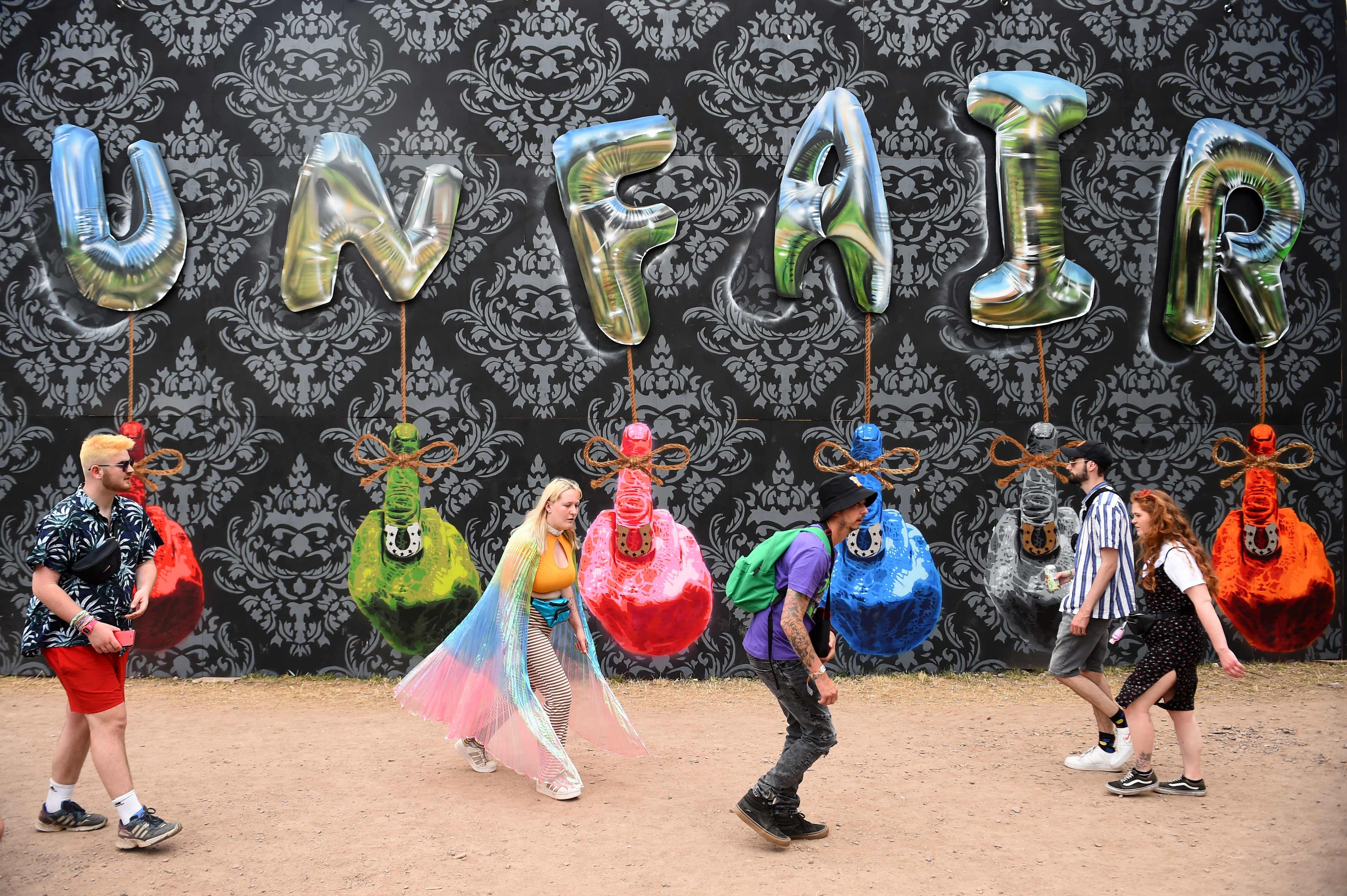 Festivalgoers walk at the Unfair Ground during last year’s Glastonbury festival