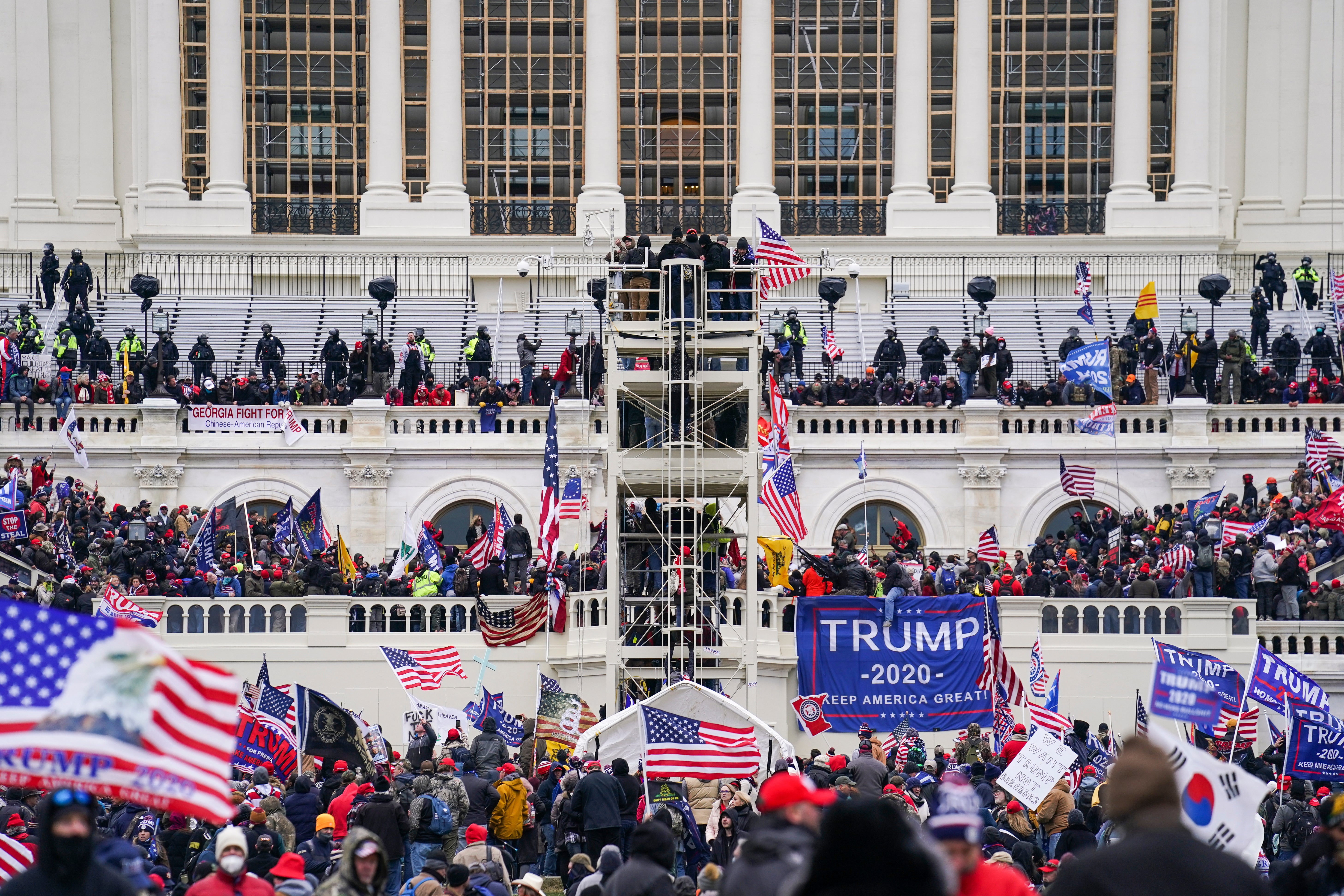 Rioters breach the Capitol grounds on Jan 6