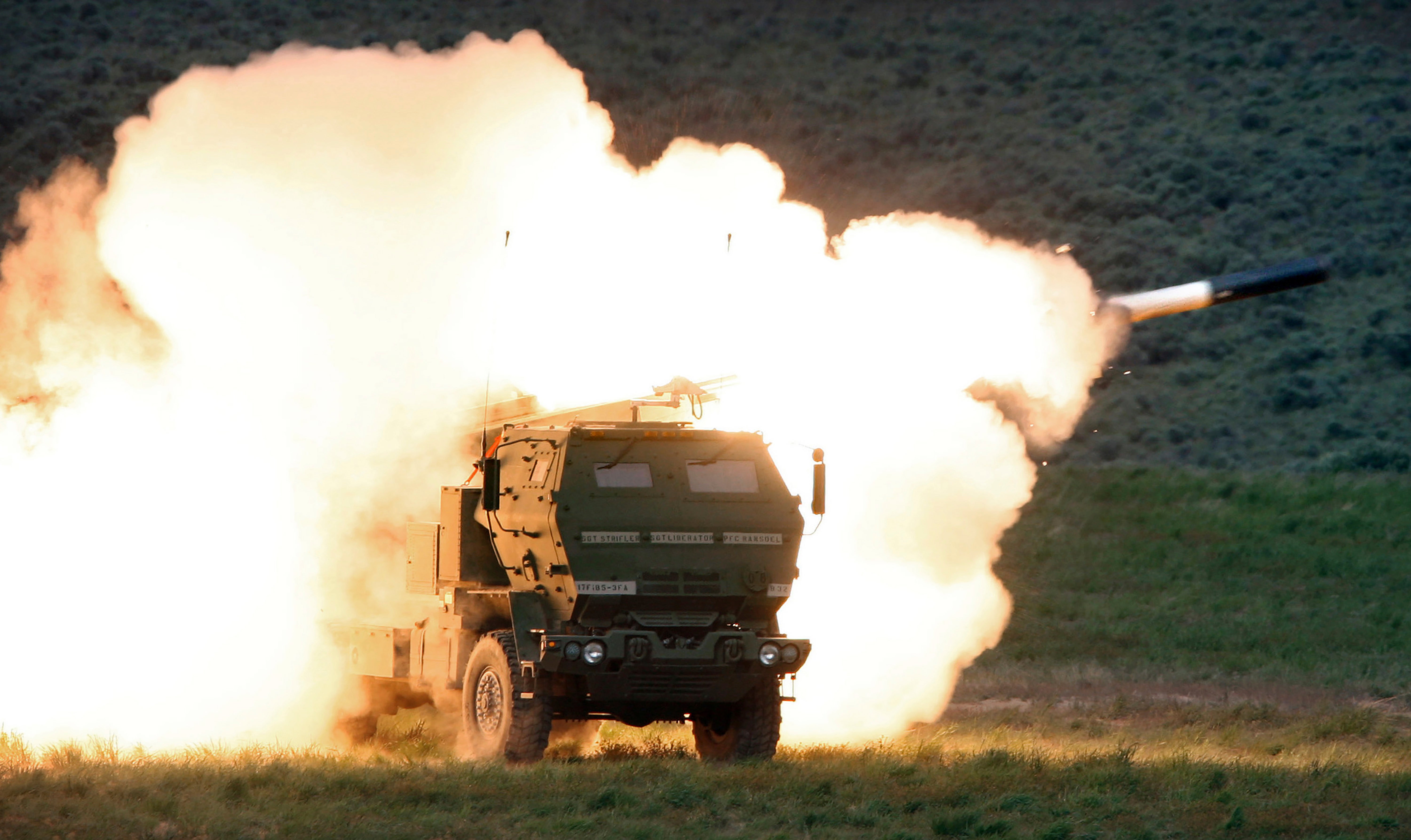 A launch truck fires the High Mobility Artillery Rocket System (HIMARS)