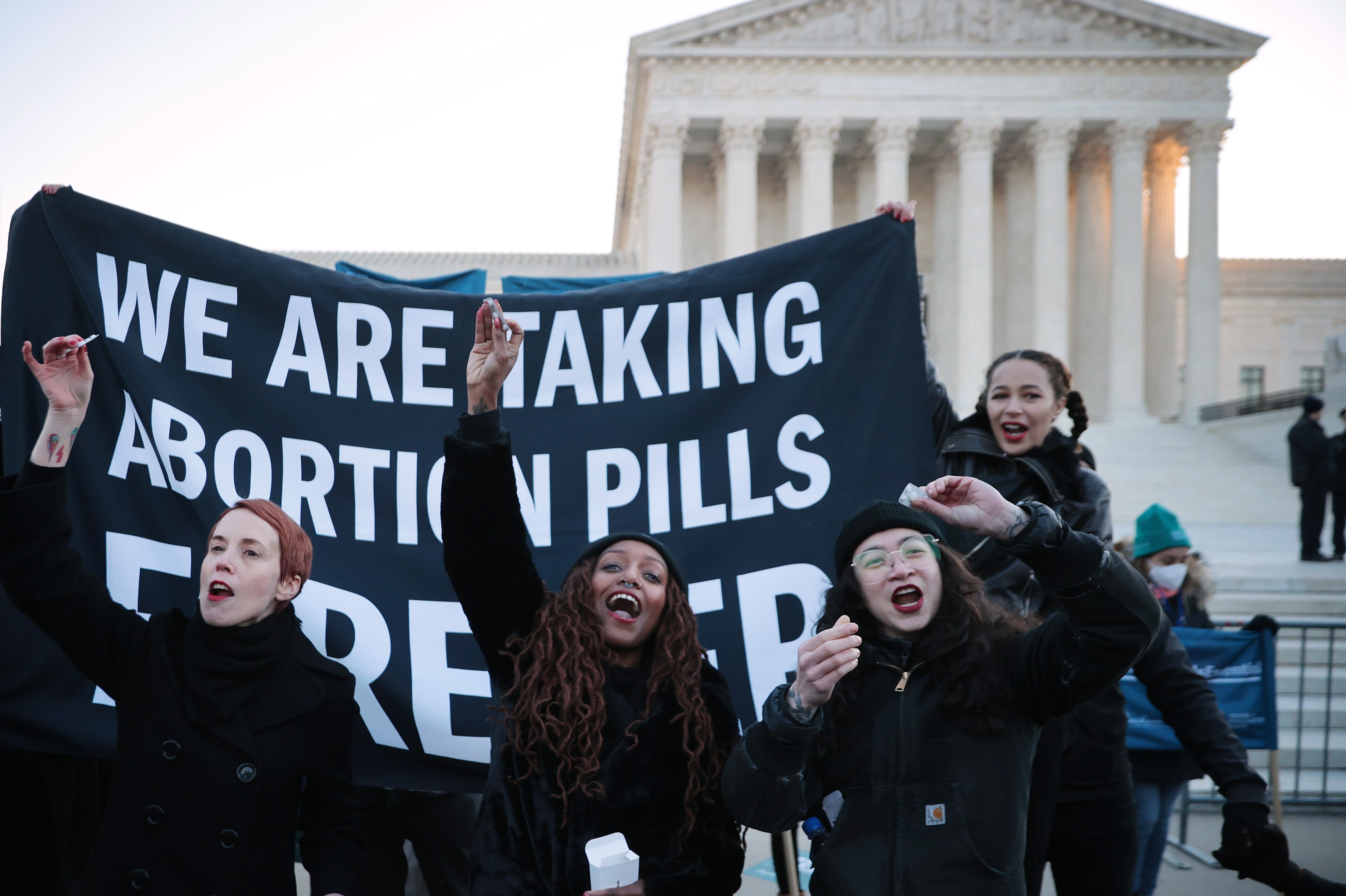 Abortion rights activists took abortion drugs outside the US Supreme Court in December 2021 as justices heard oral arguments in a Mississippi case that could determine the fate of abortion access for millions of Americans.