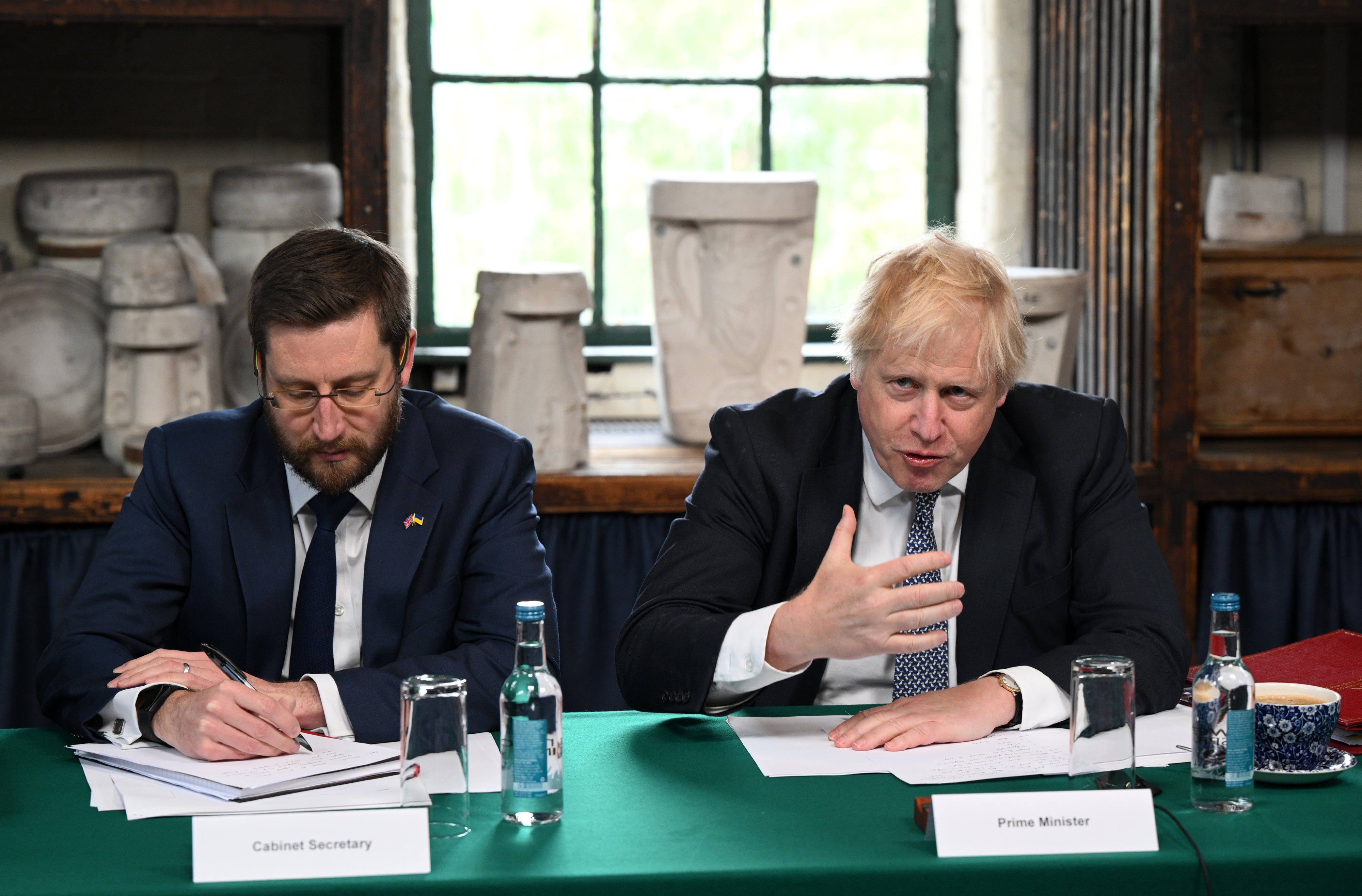 Cabinet secretary Simon Case and Boris Johnson