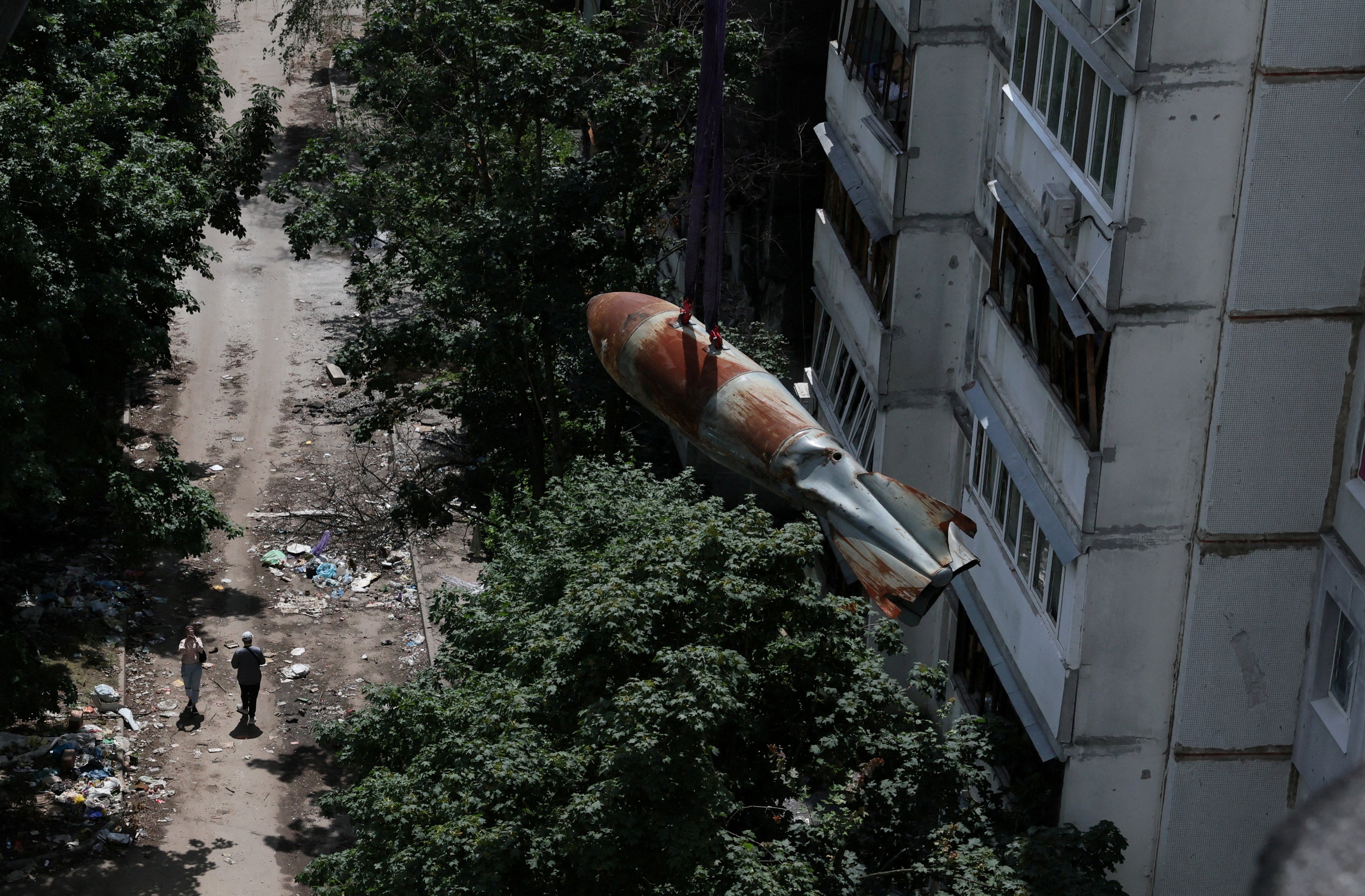 The bomb in mid-air as it is taken off the apartment block in Kharkiv