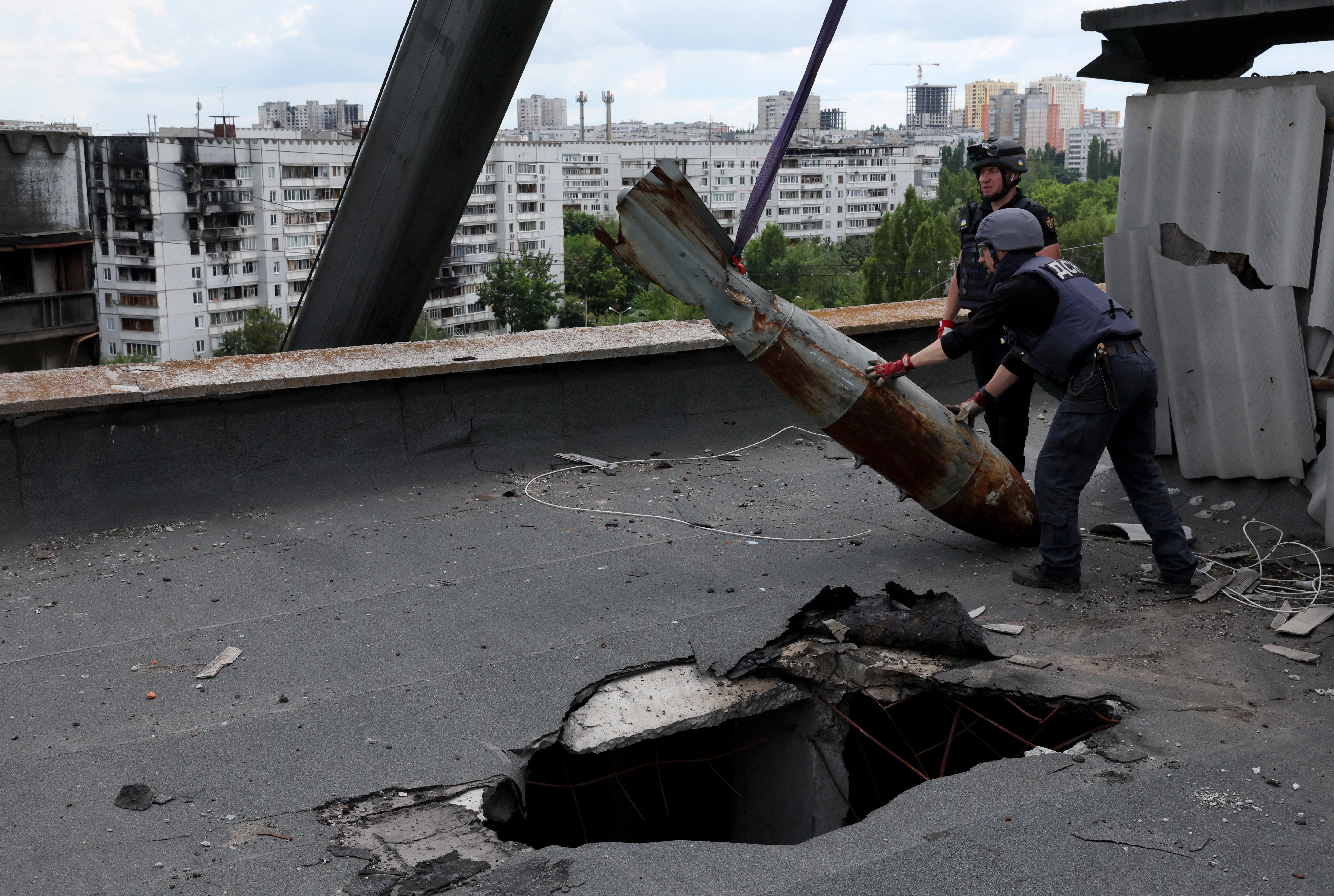 The bomb is very slowly and deliberately moved from the roof using a crane